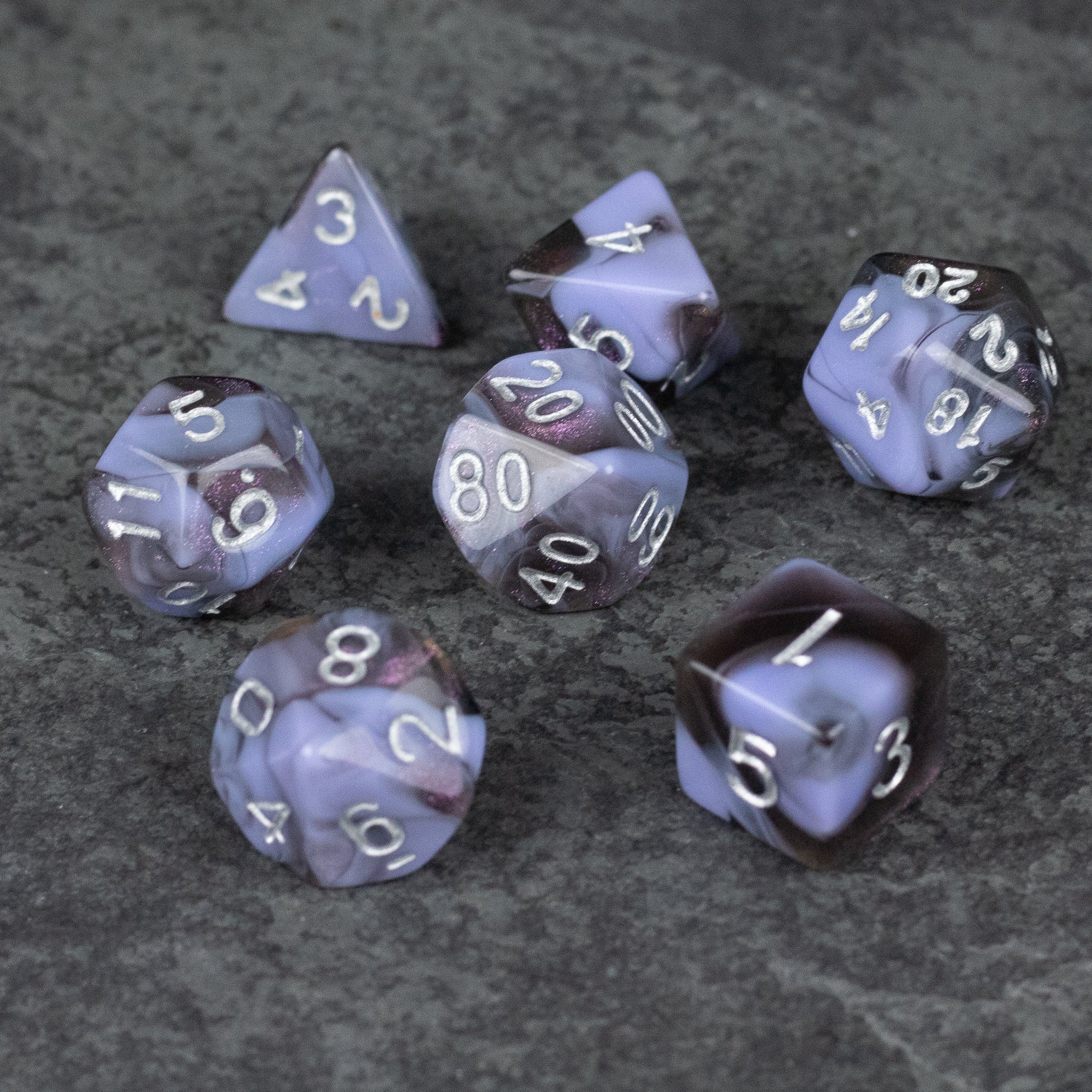Periwinkle and Black Marbled Dice Set - Set of seven marbled acrylic dice in periwinkle and black with white numbering, including d4, d6, d8, d10, d12, d20, and.