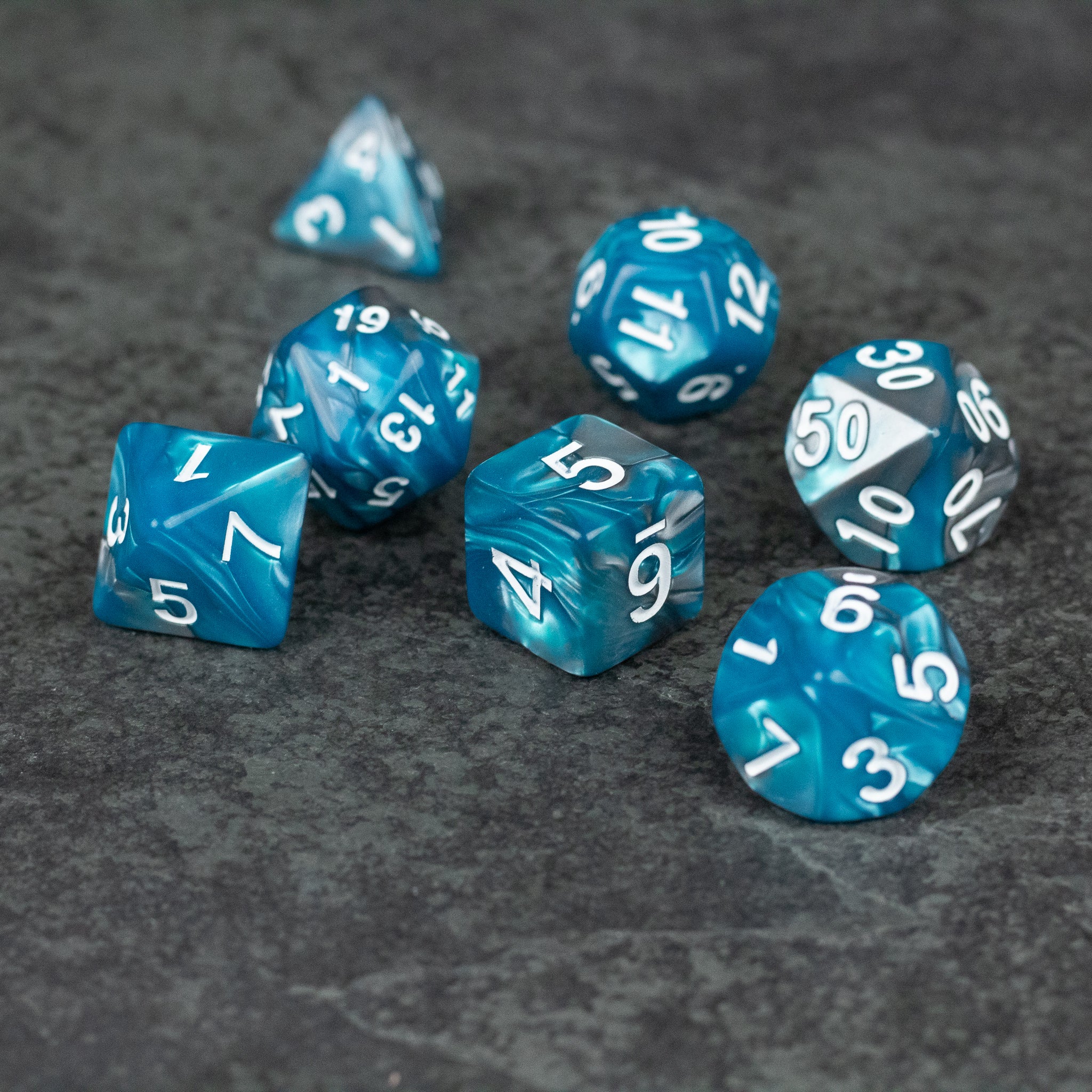 Blue and Gray Marbled Dice - Set of seven blue and gray marbled acrylic dice with white numbers, including d4, d6, d8, d10, d12, d20, and percentile dice.