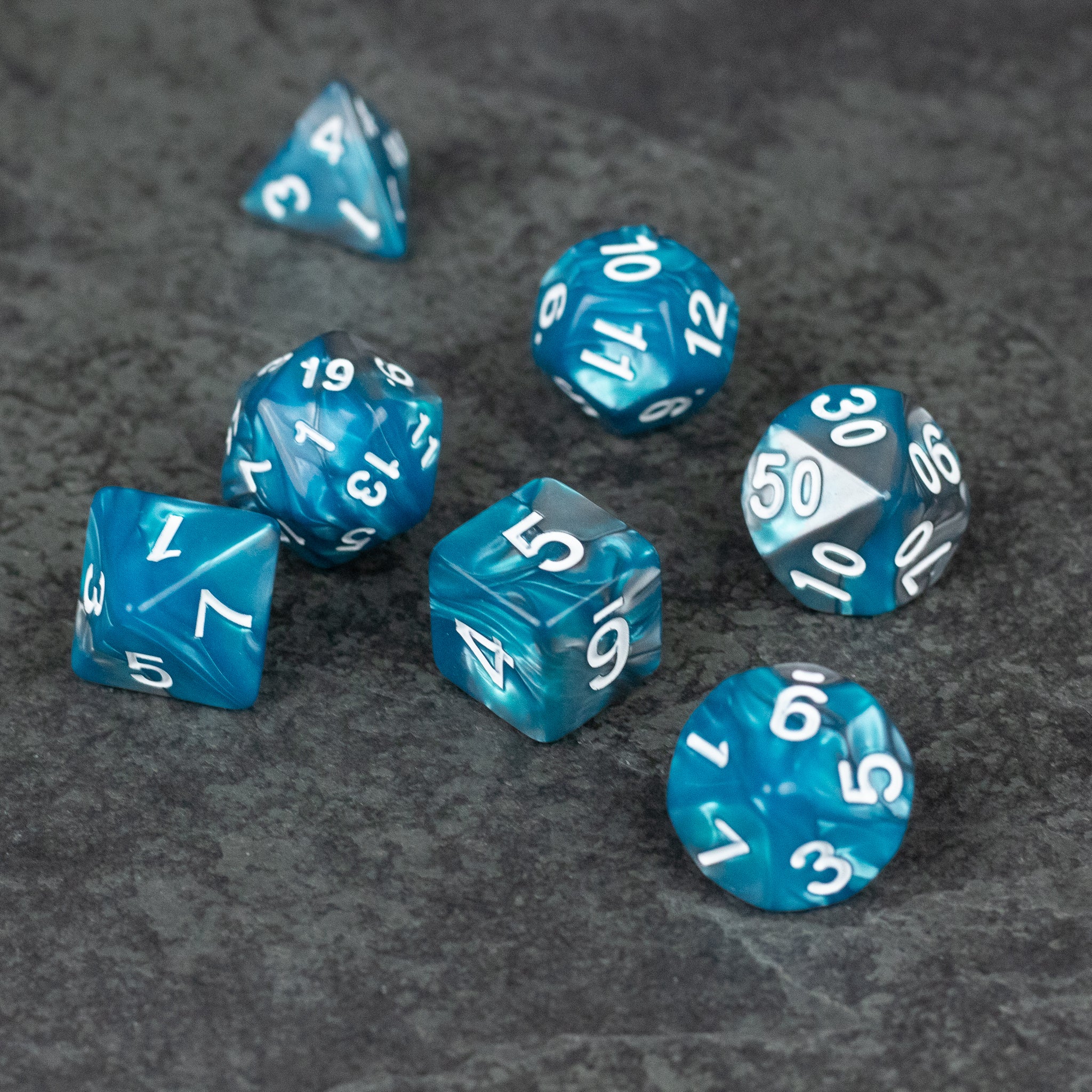 Blue and Gray Marbled Dice - Set of seven blue and gray marbled acrylic polyhedral dice with white numbering.