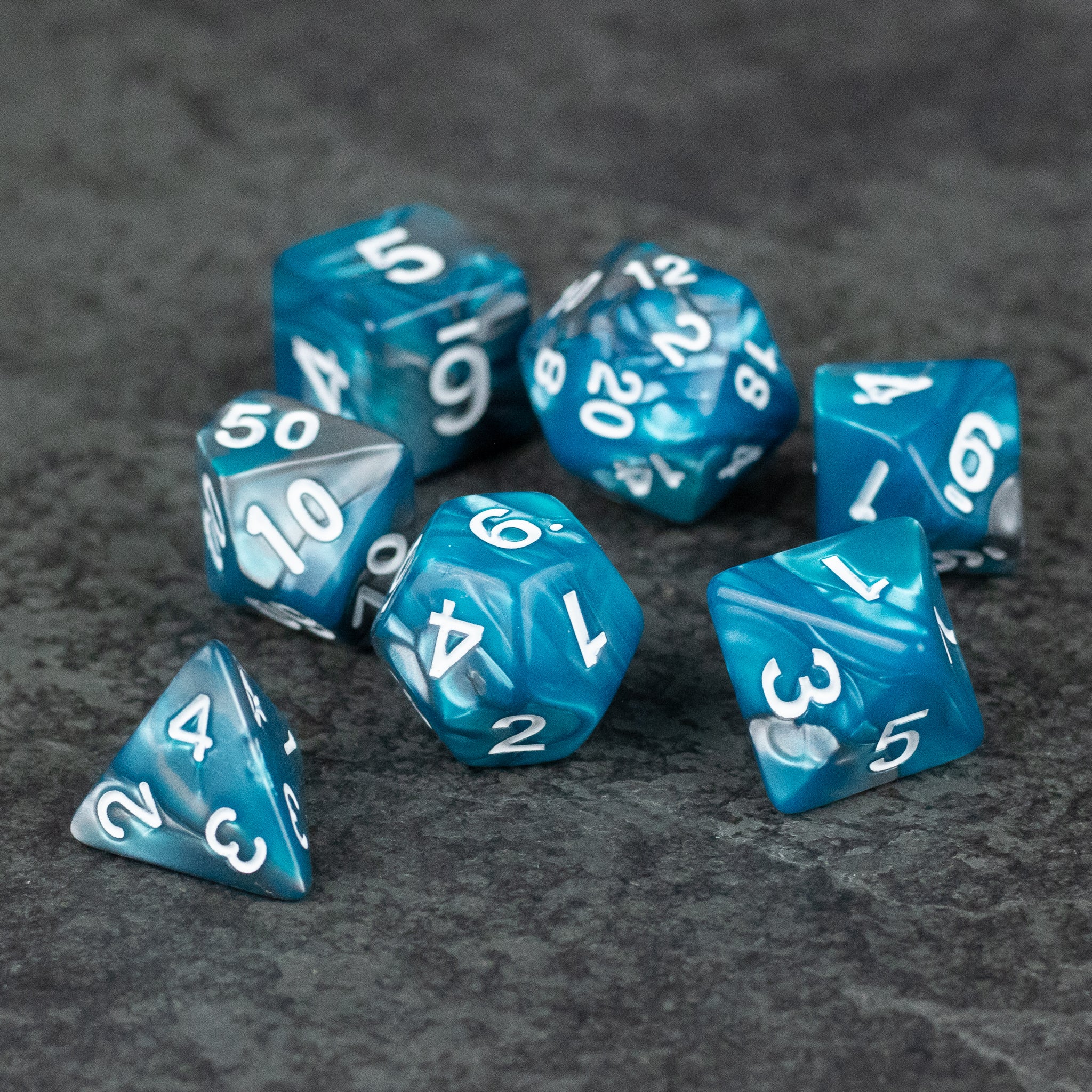 Blue and Gray Marbled Dice - Set of seven blue and gray marbled acrylic dice with white numbering, including d20, d12, d10, d8, d6, d4, and percentile.