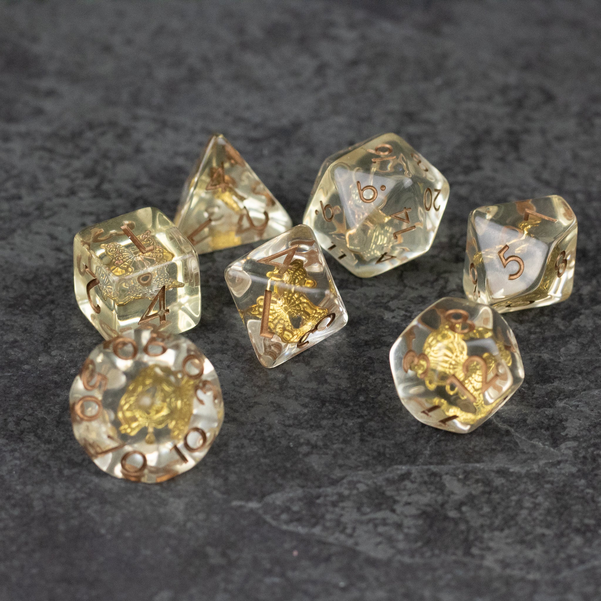 Gold Charm Butterfly Dice Set - Transparent polyhedral dice set with embedded gold butterfly charms and gold numbering.