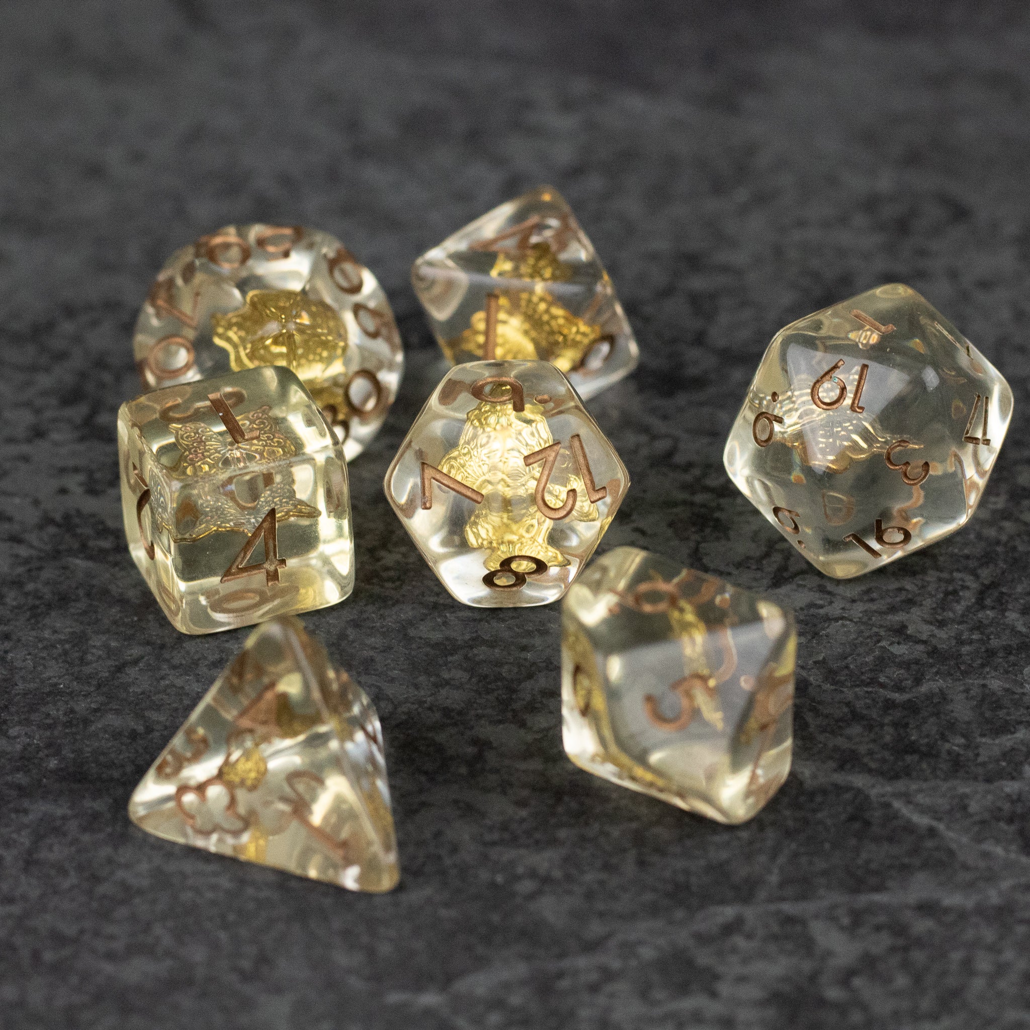 Gold Charm Butterfly Dice Set - Transparent polyhedral dice set with gold butterfly charms inside and gold numbering.