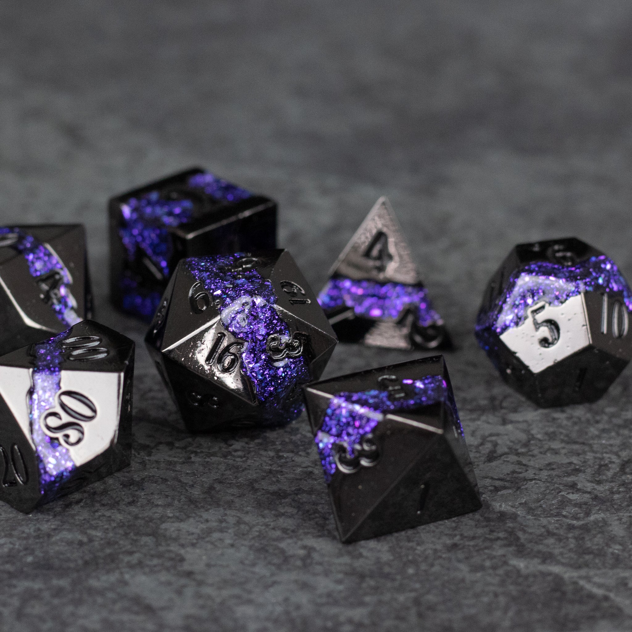 Purple Rift Dice Set - Set of metal purple and black polyhedral dice with white numbering, textured and glossy finish.