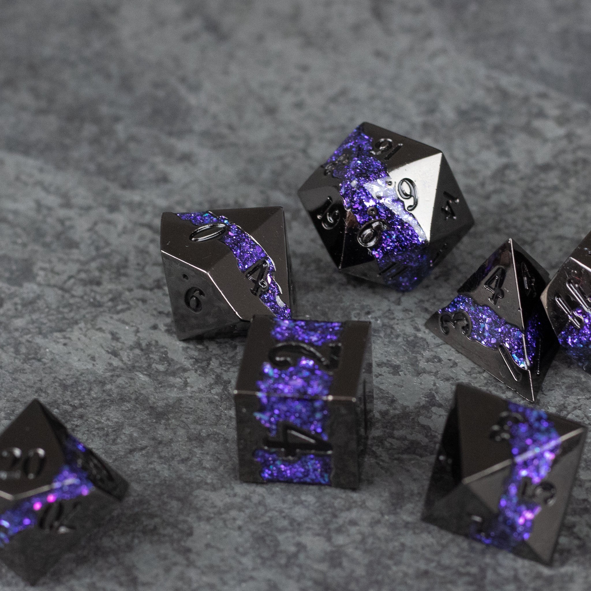 Purple Rift Dice Set - Set of black metal dice with shimmering purple rift-like cracks, featuring sharp edges and engraved numbers.