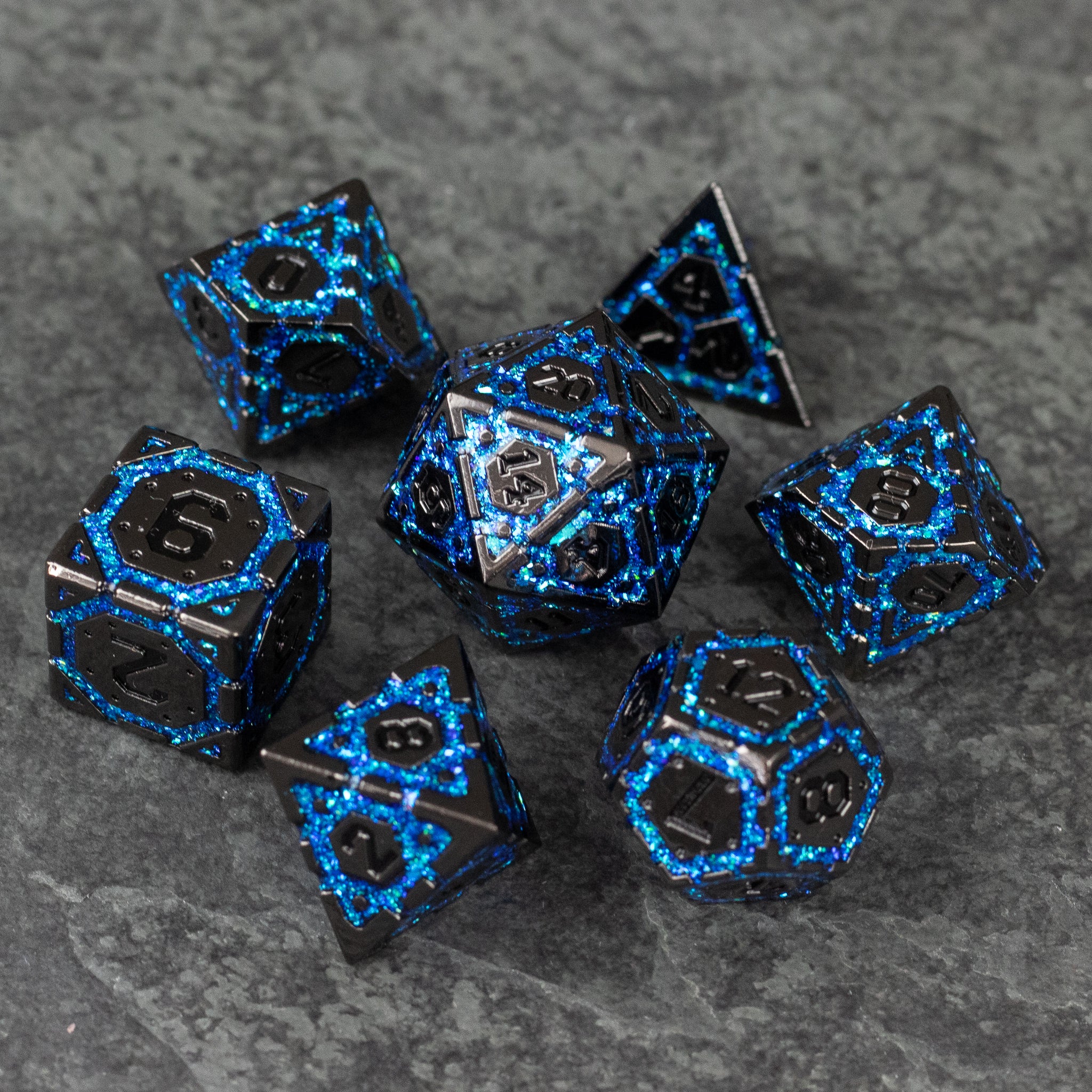 Blue Arcane Ward - Seven black metal polyhedral dice with glowing blue arcane-style patterns and numbers.