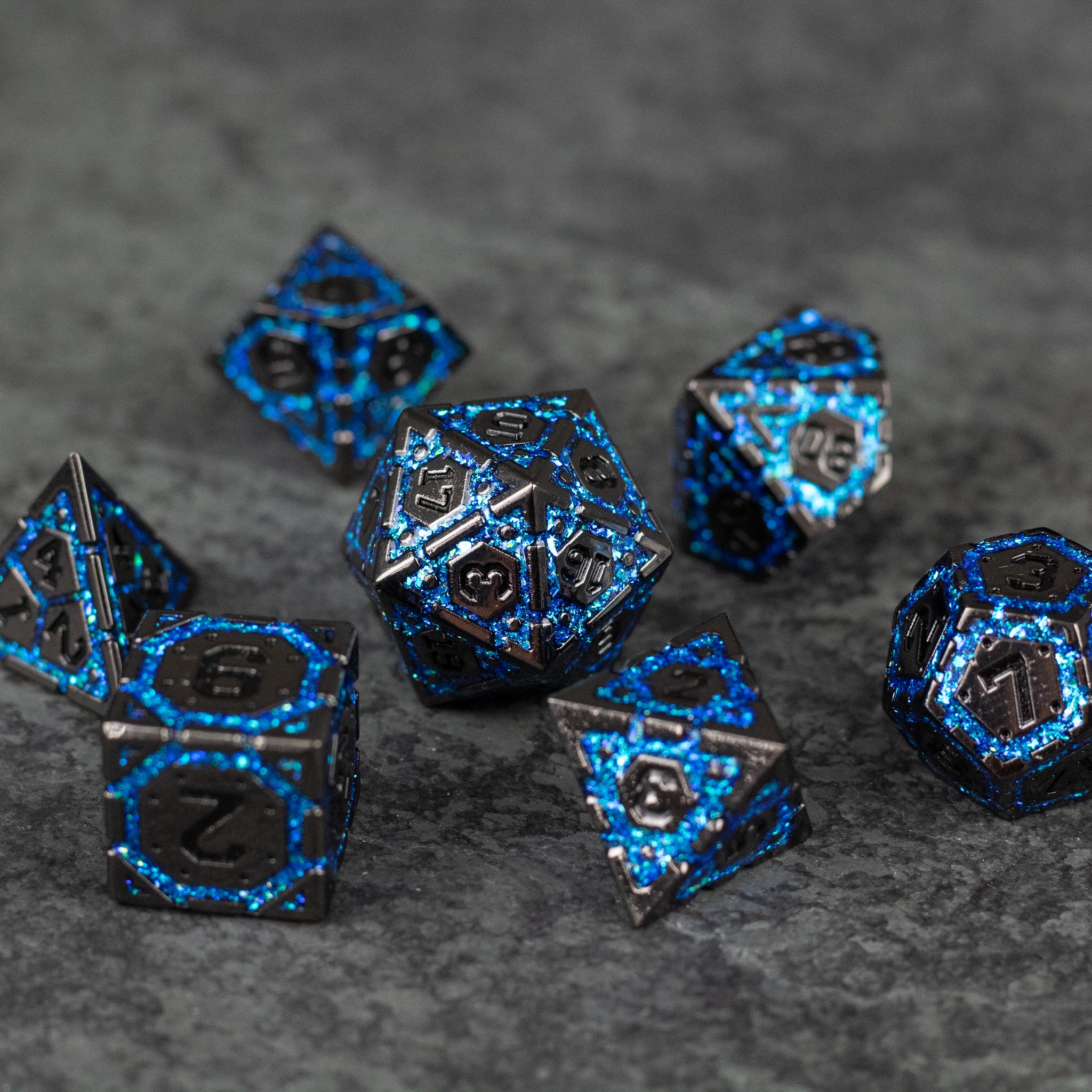 Blue Arcane Ward - Set of black metal polyhedral dice with glowing blue arcane-style numbers and intricate mystical designs.