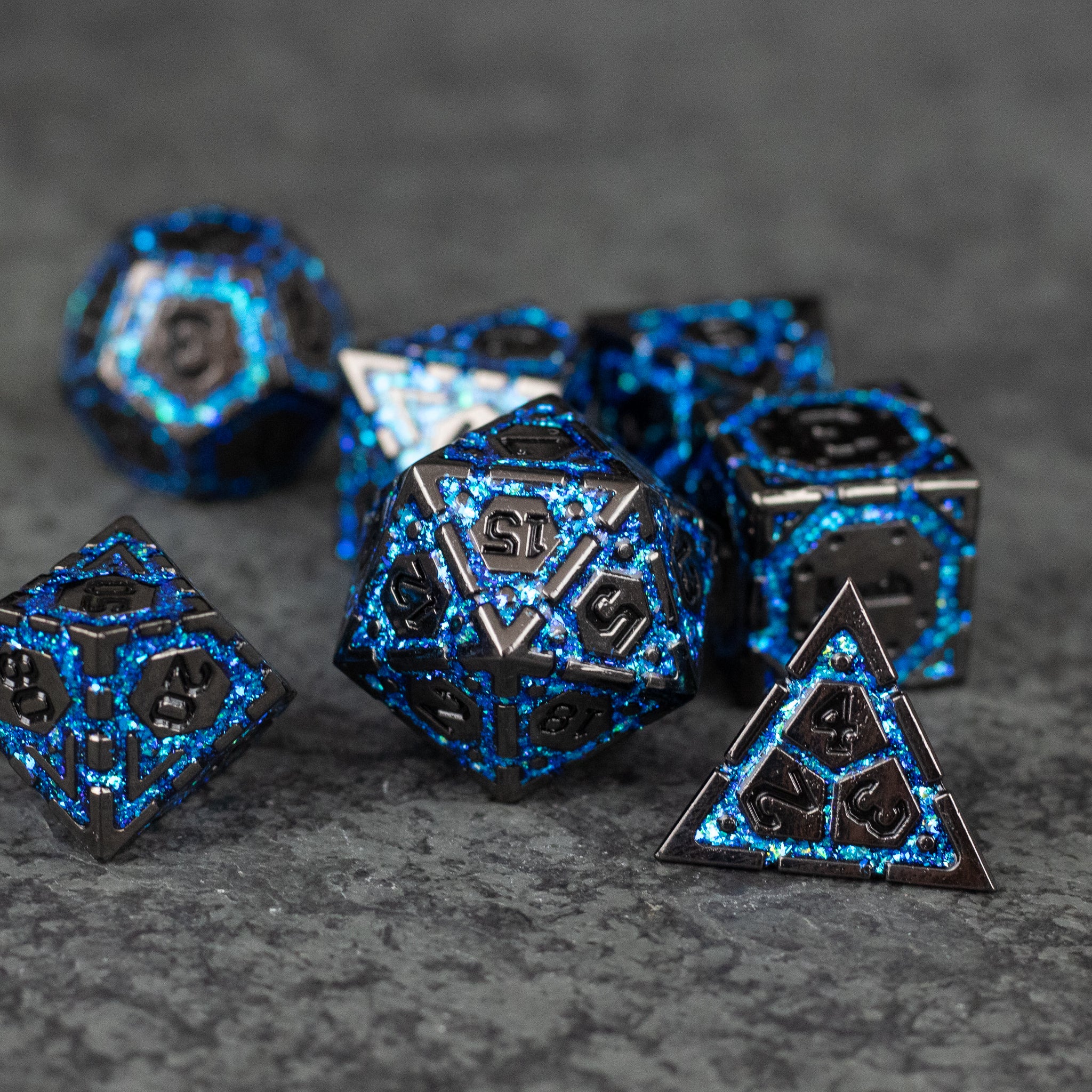 Blue Arcane Ward - Set of black metal polyhedral dice with glowing blue arcane patterns, including d20, d12, d10, d8, d6, and d4 shapes.