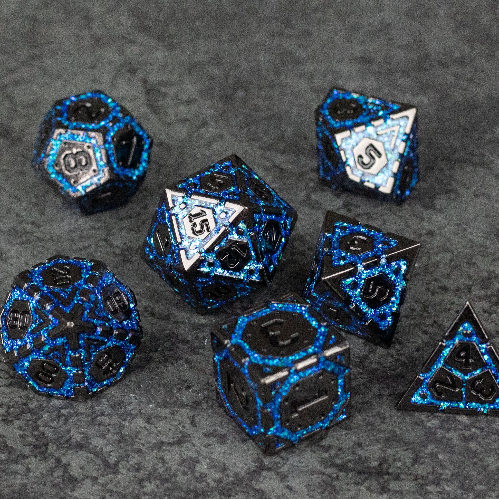 Blue Arcane Ward - Set of black metal polyhedral dice with glowing blue arcane rune patterns on each face, designed for tabletop gaming.