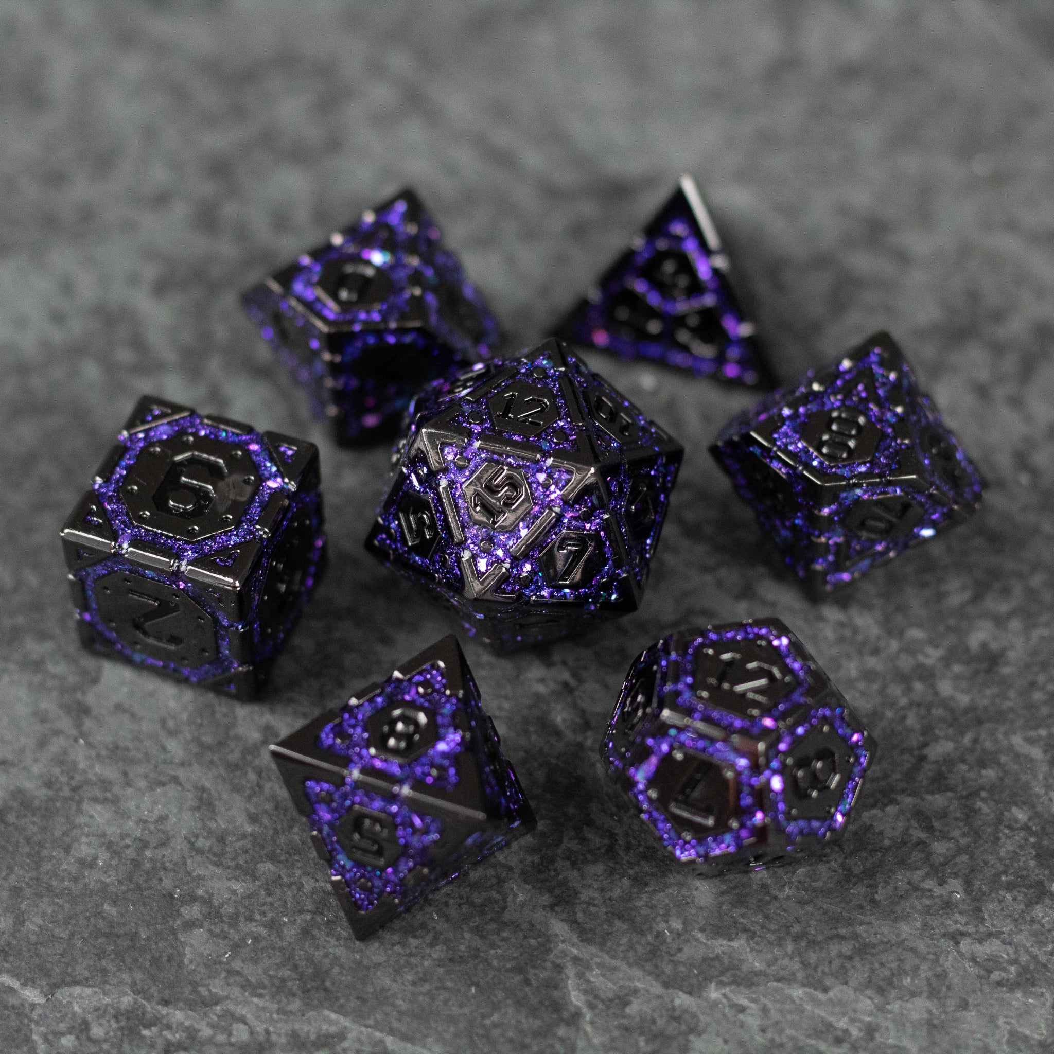 Purple Arcane Ward Dice Set - Metallic black and purple arcane-themed seven-piece dice set on gray stone surface.