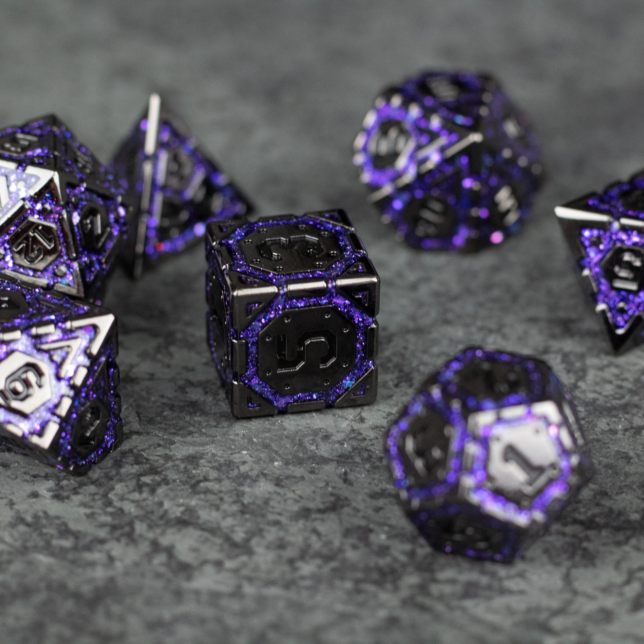 Purple Arcane Ward Dice Set - Seven black metal dice with intricate glowing purple arcane designs, including d4, d6, d8, d10, d12, d20, and percentile.