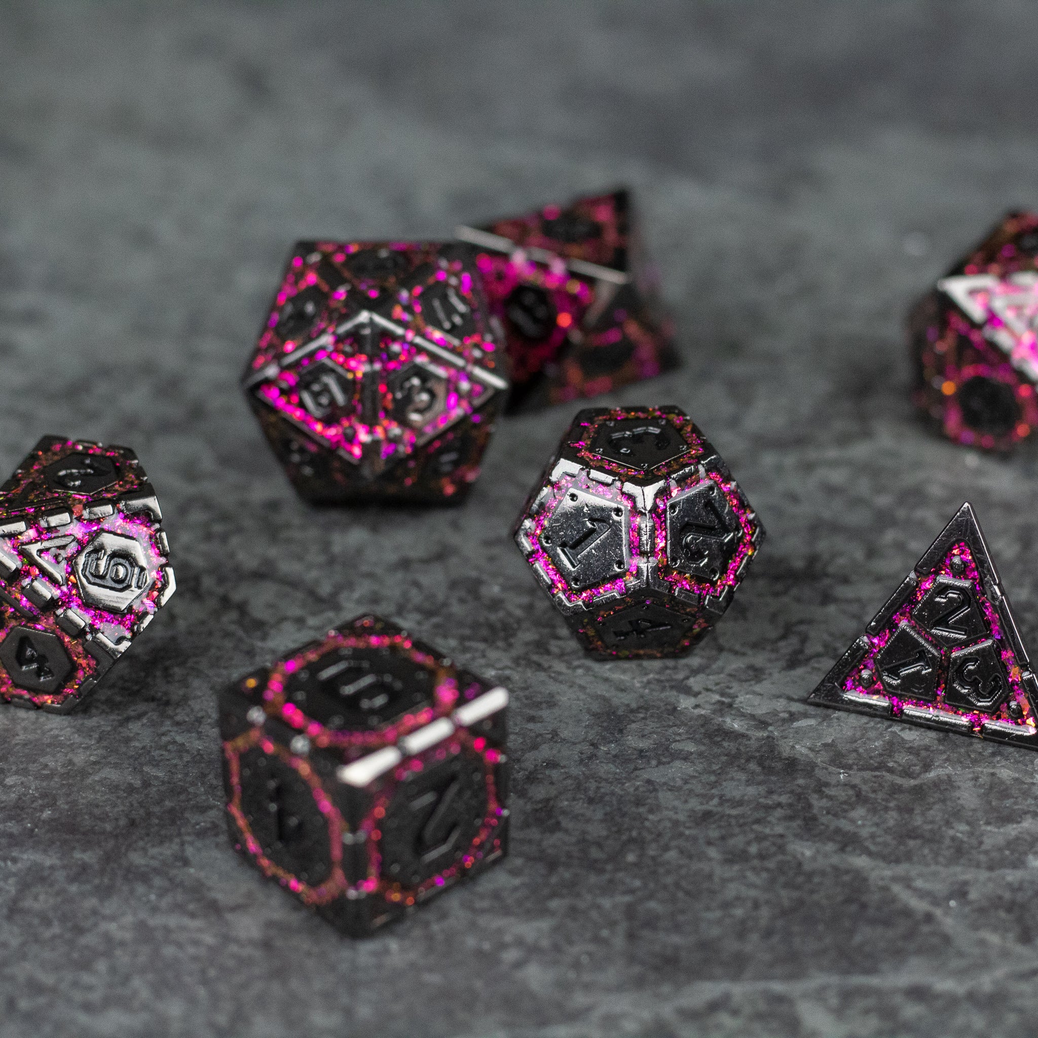 Pink Arcane Ward - Set of metal polyhedral dice with black faces and bright pink glowing edges on a gray surface.