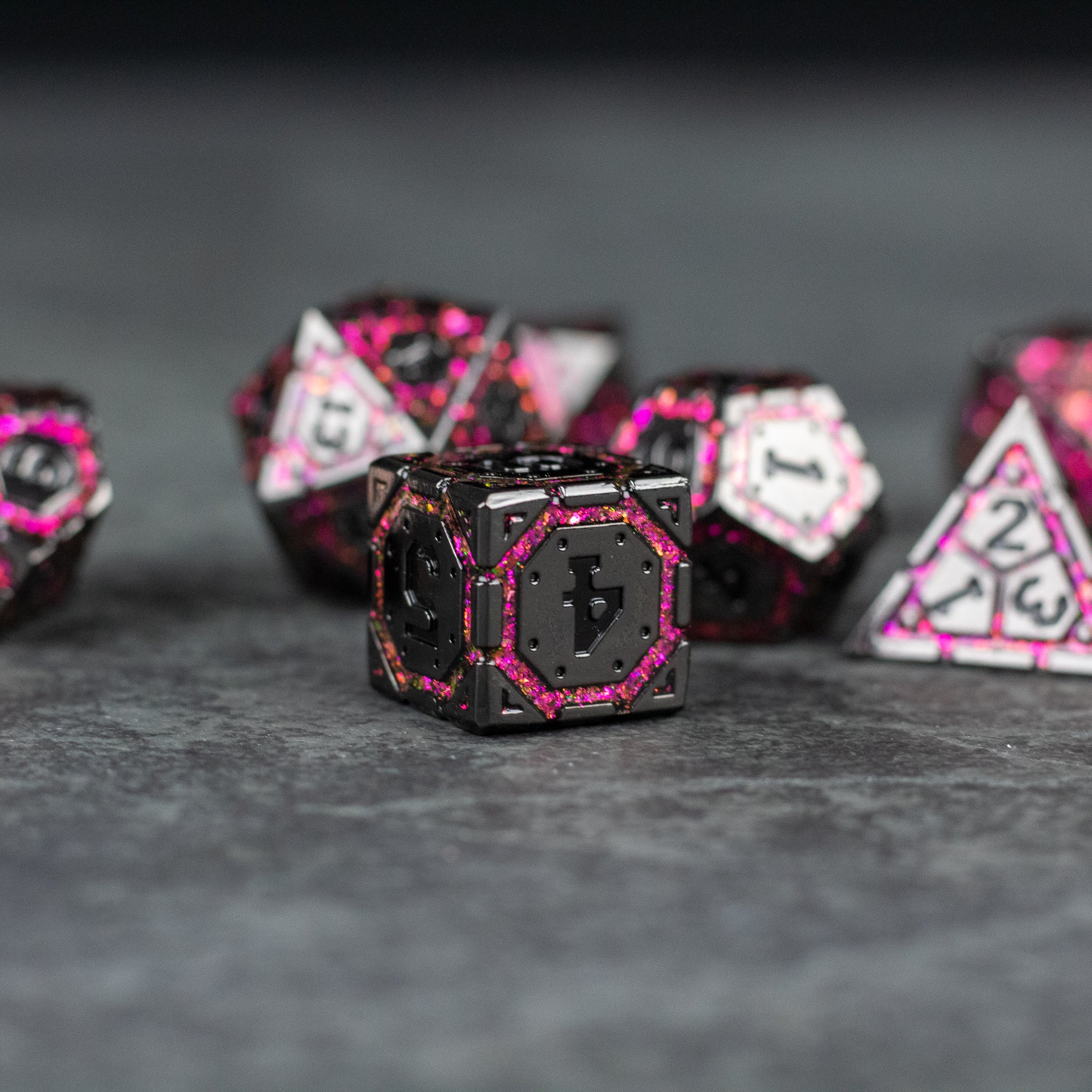 Pink Arcane Ward - Black metal dice with bright pink edges and arcane-inspired symbols for tabletop gaming.