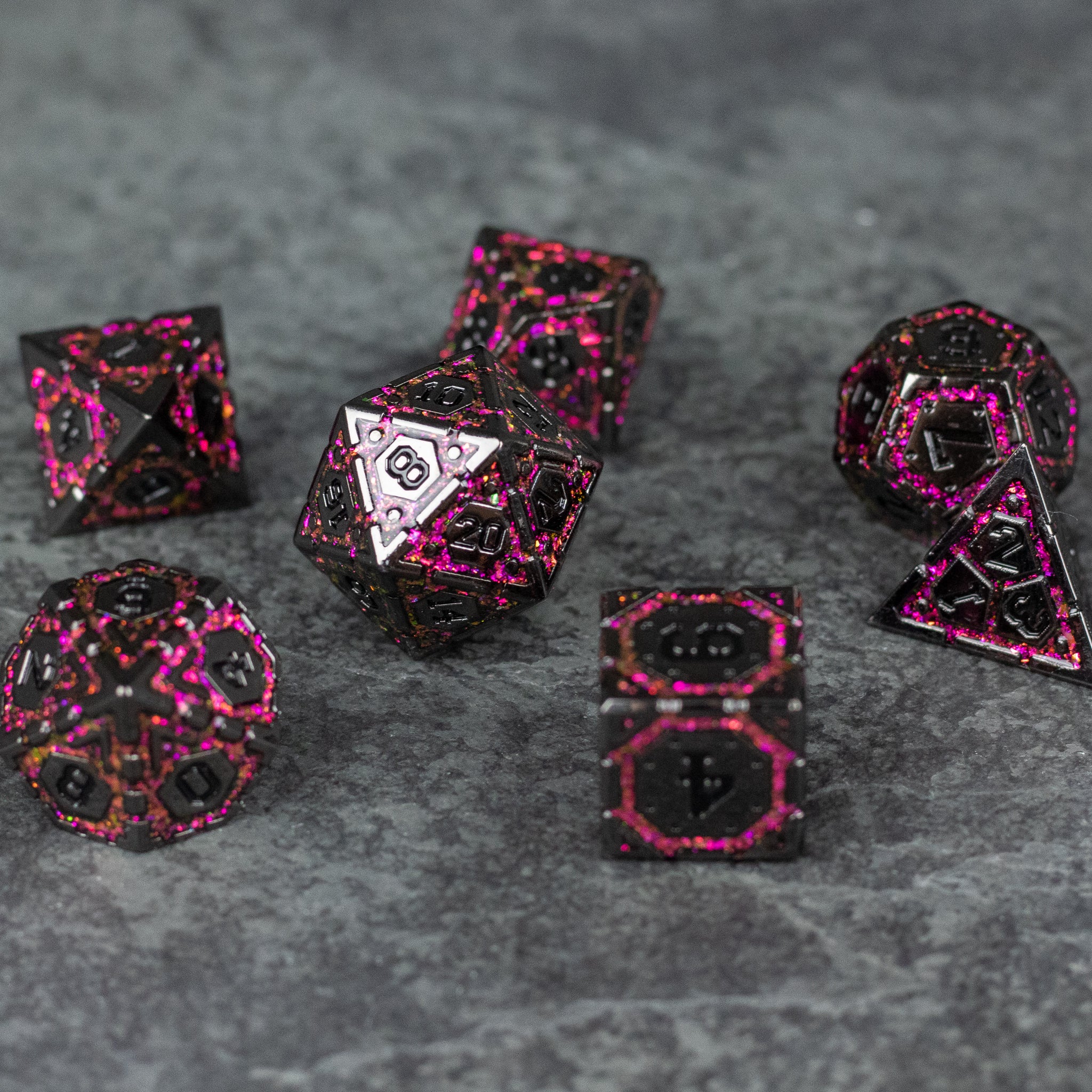 Pink Arcane Ward - Set of seven black metal dice with bright pink arcane rune designs, featuring various polyhedral shapes.