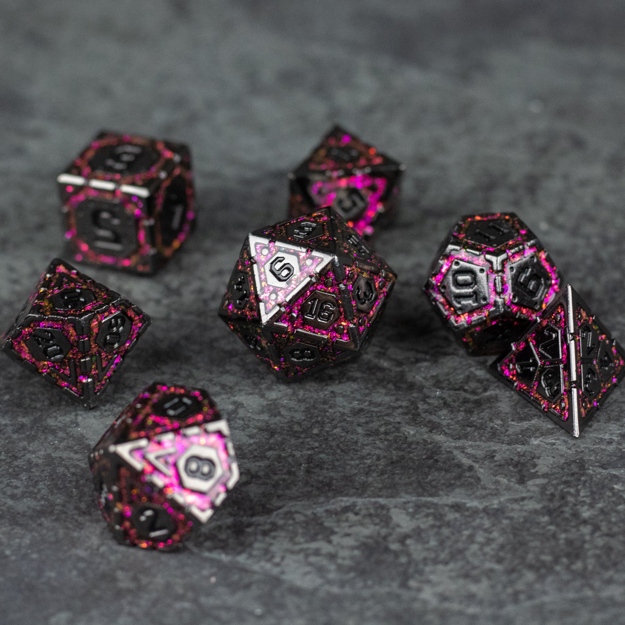 Pink Arcane Ward - Set of seven black metal polyhedral dice with bright pink edges and numbers, designed for tabletop gaming.