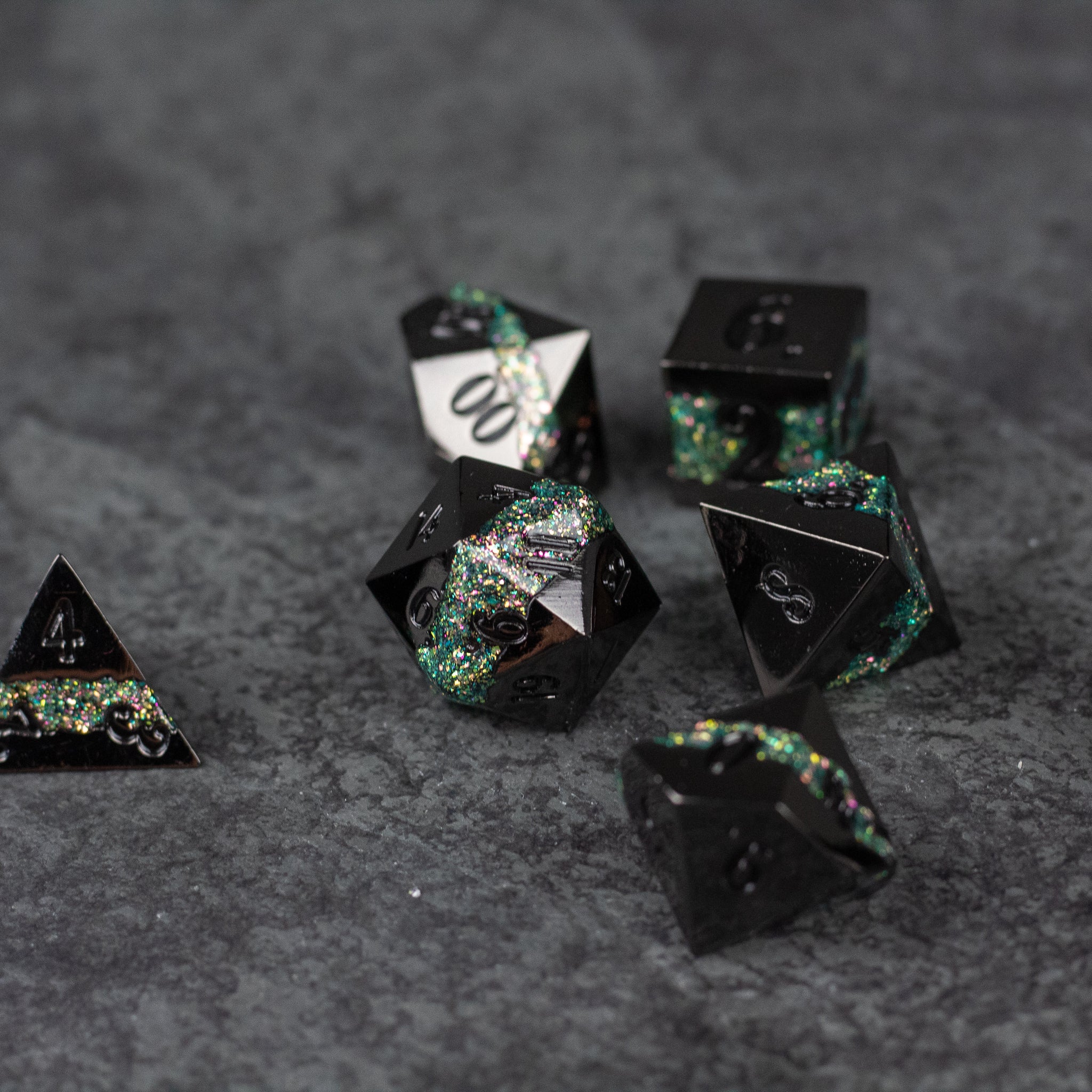 Light Green Rift Dice Set - Black and light green metal polyhedral dice set with shimmering green flecks on gray surface.