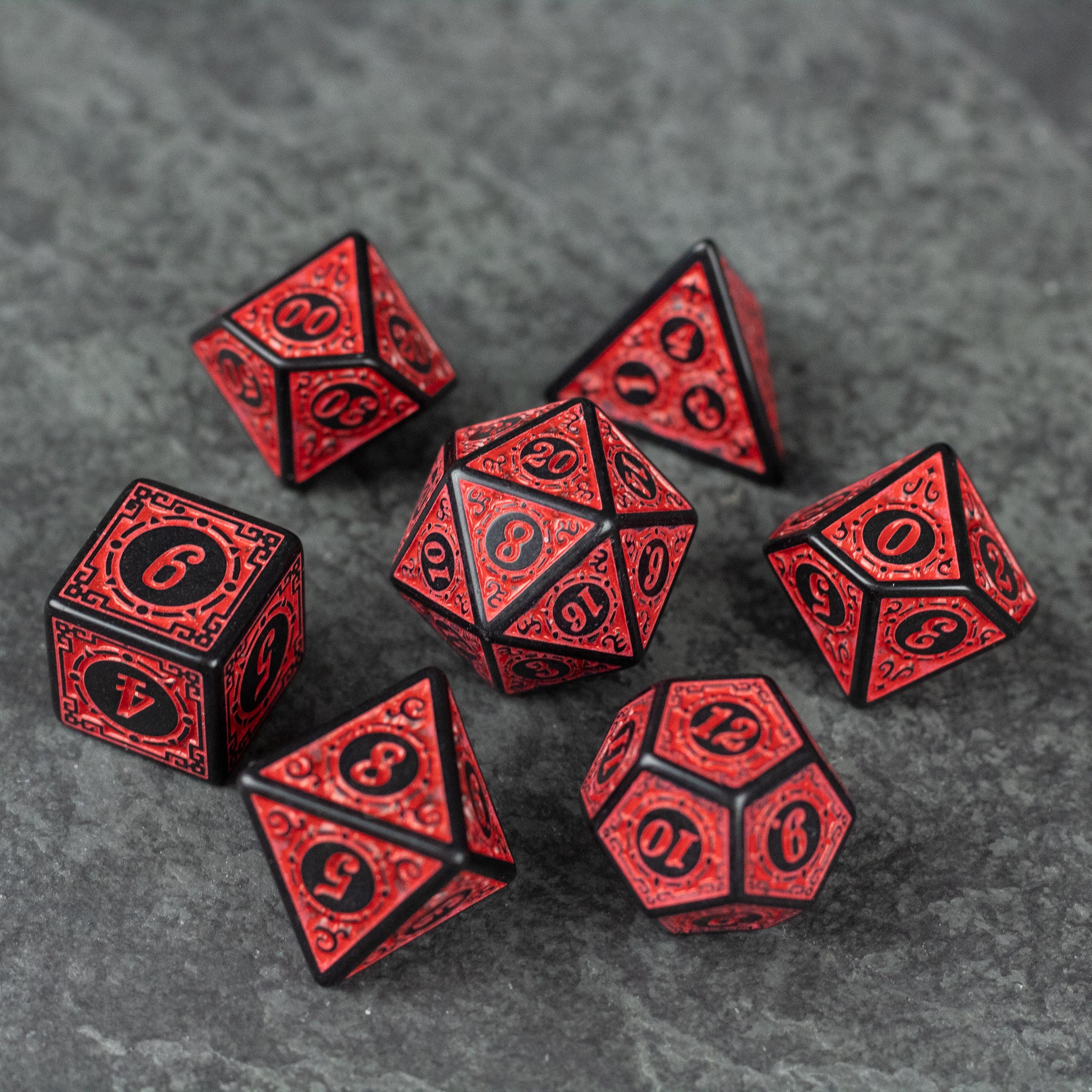 Red Runes Acrylic Dice Set - Set of seven red acrylic dice with black engraved numbers and intricate rune designs.
