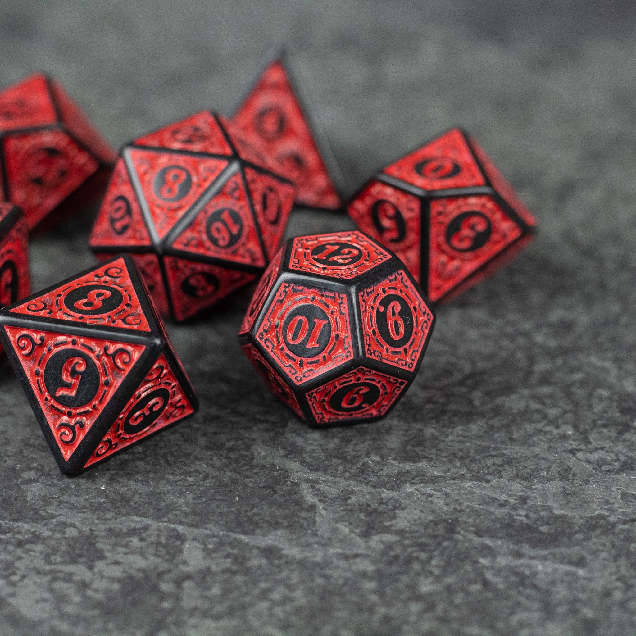 Red Runes Acrylic Dice Set - Set of red acrylic polyhedral dice with black intricate rune designs on each face.