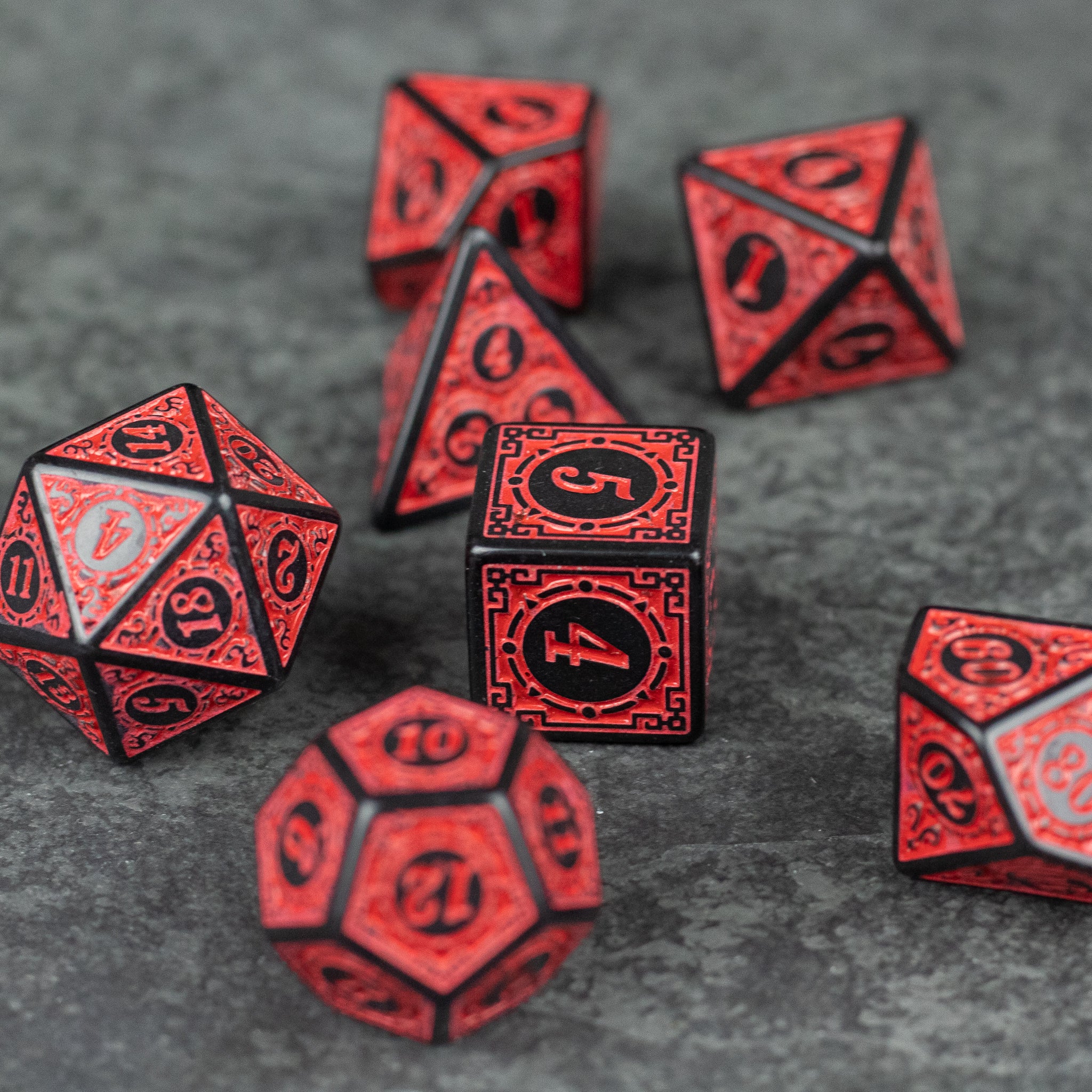 Red Runes Acrylic Dice Set - Red acrylic dice set with black rune-style numbers, including d20, d12, d10, d8, d6, and d4 shapes on a dark surface.