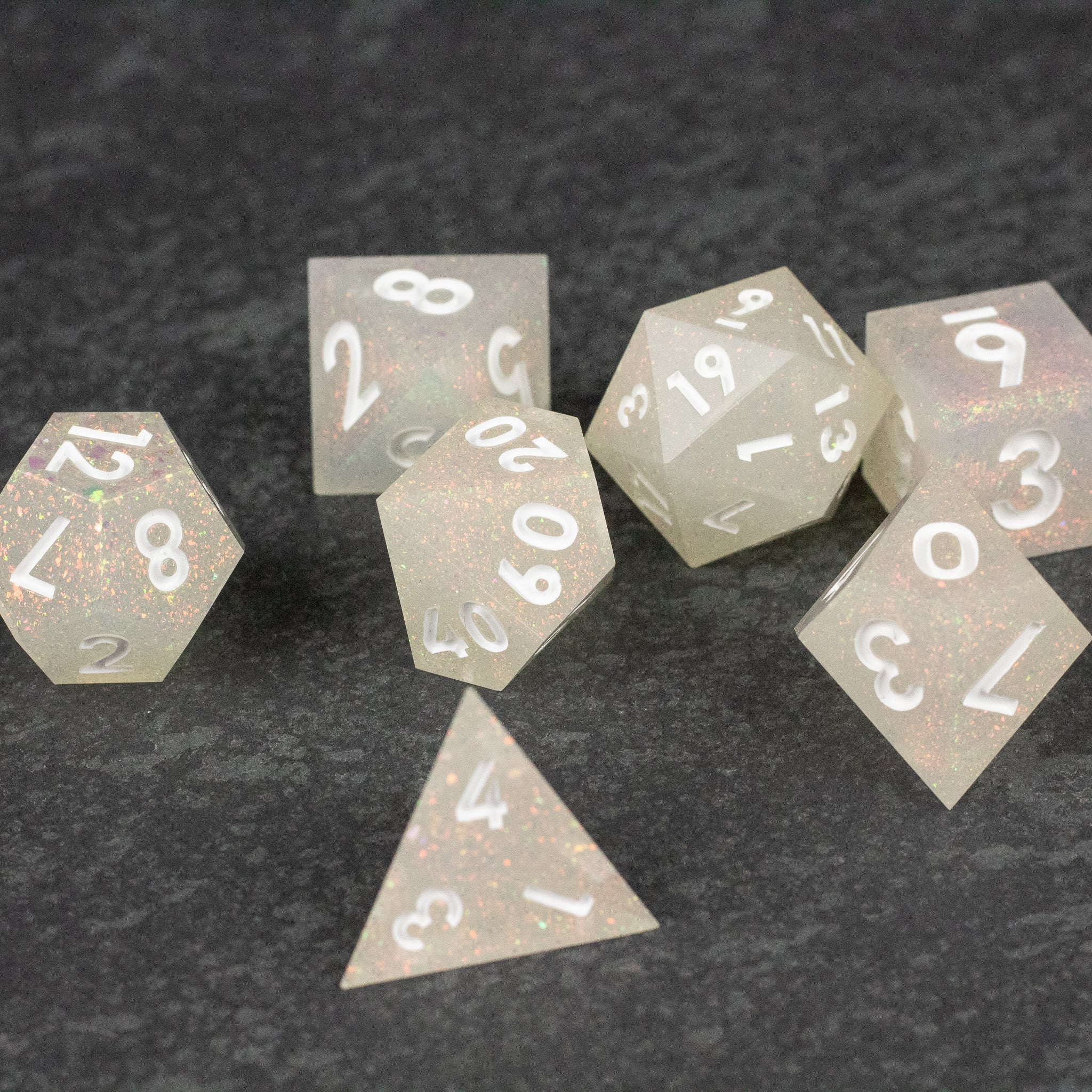 Snowfield Dice Set - White translucent polyhedral dice set with sharp edges and pearlescent finish.