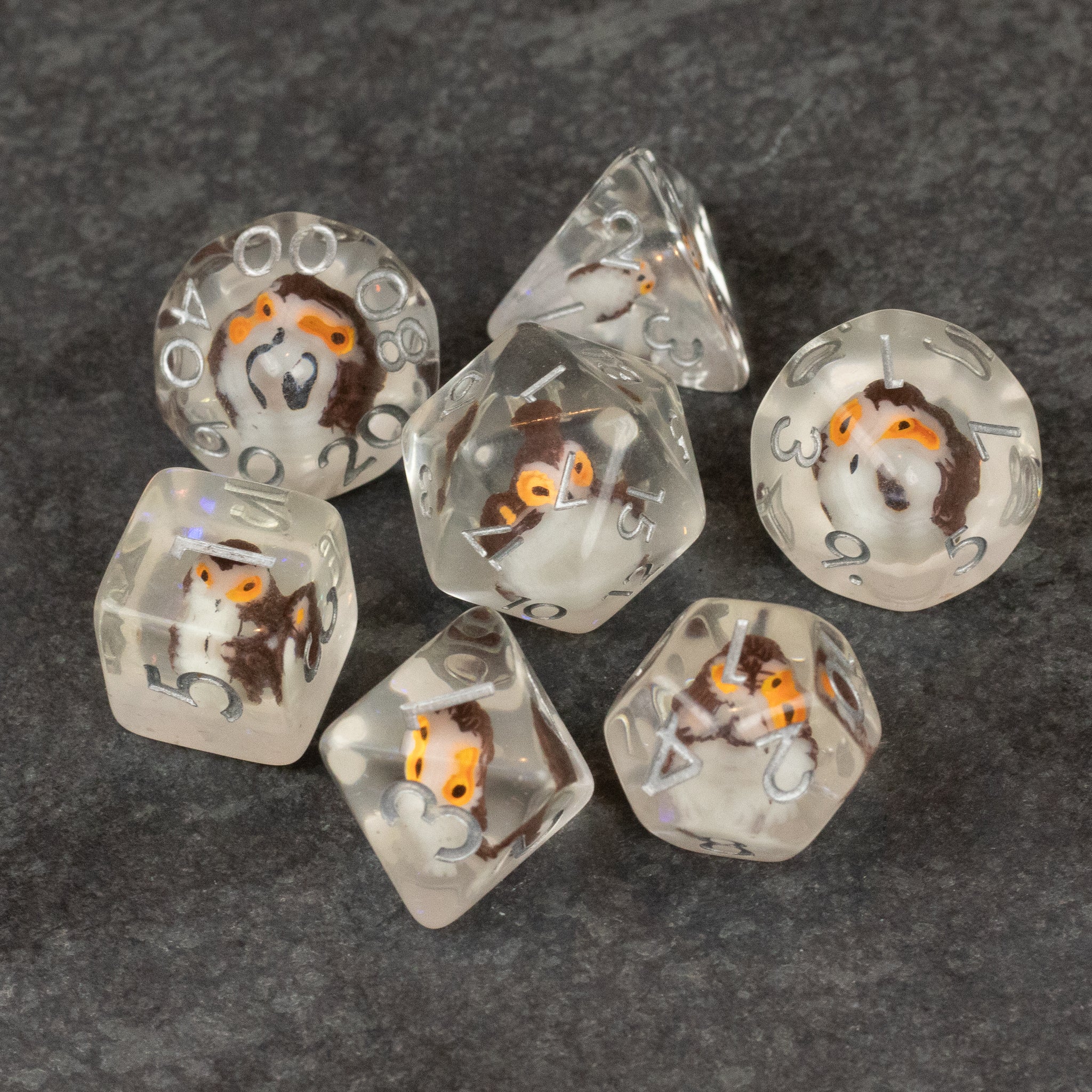 Owl Dice Set - Transparent polyhedral dice set with small orange and white owl figures inside, including d4, d6, d8, d10, d12, and d20.