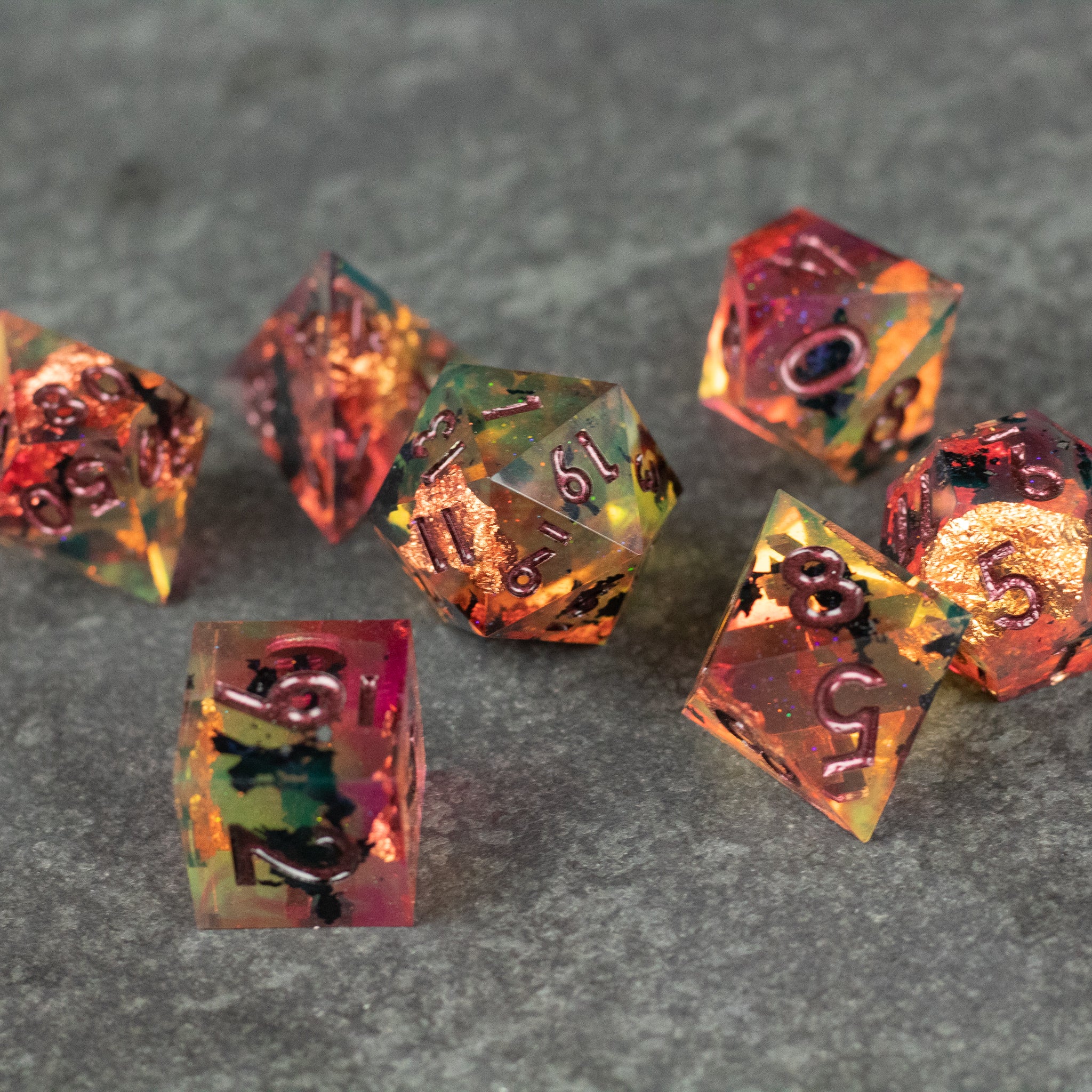 Dawn Ritual Dice Set - Seven polyhedral dice with sharp edges, translucent orange and yellow with black numbers, designed for tabletop gaming.