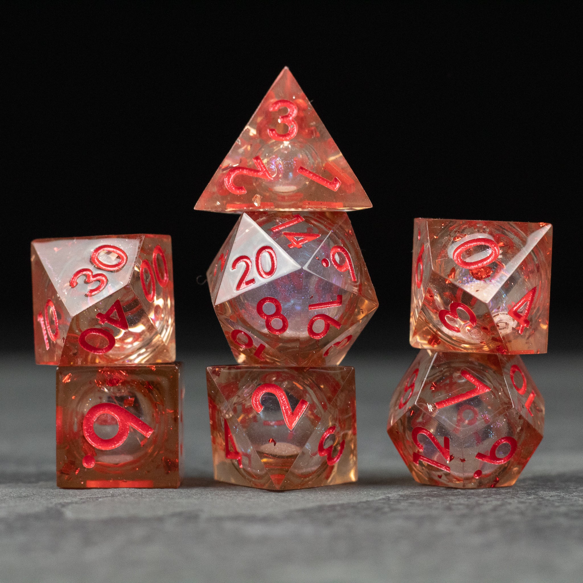 Potion of Fire Breath - Liquid Core Dice Set - Red and translucent sharp-edged polyhedral dice with swirling liquid core for tabletop gaming.