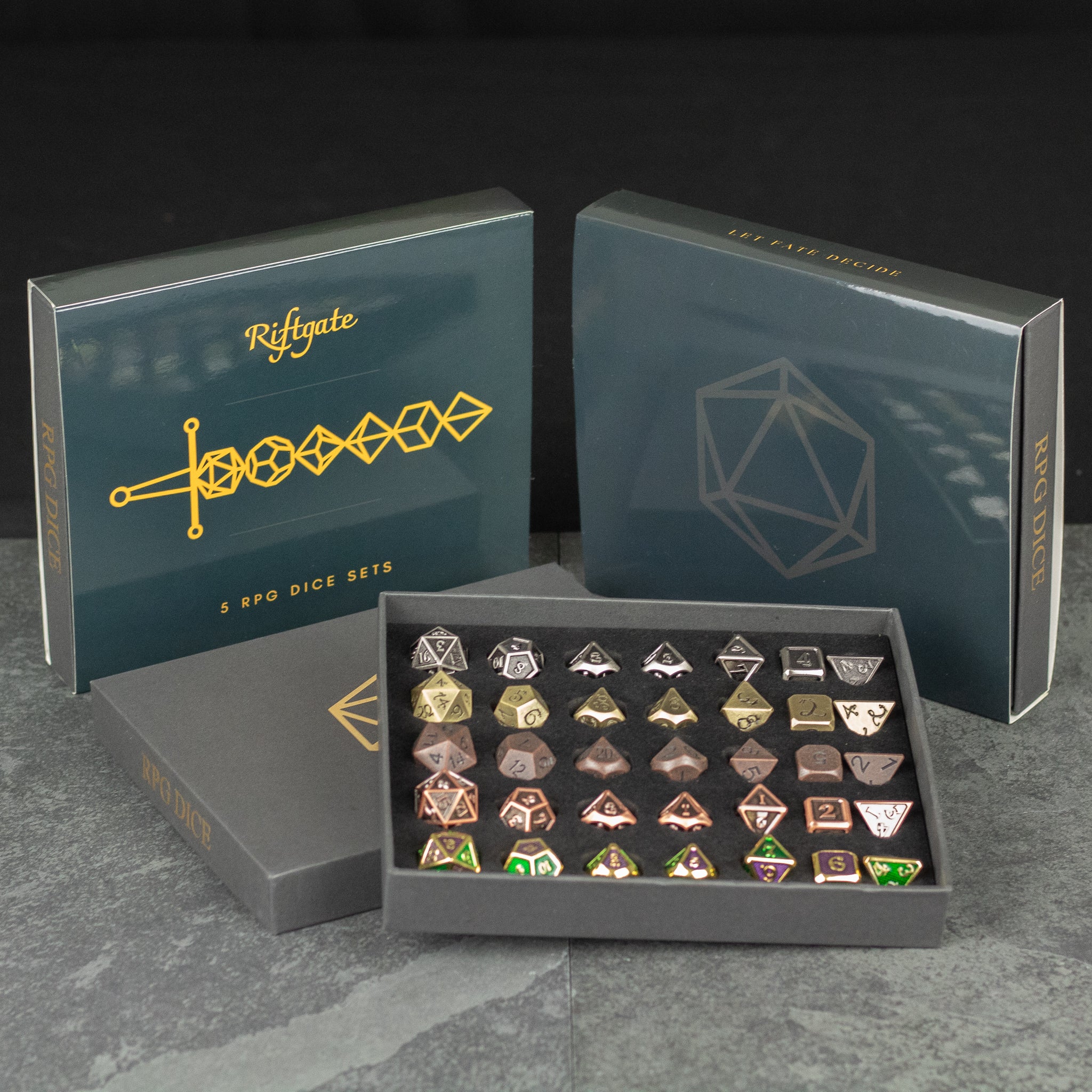 Metal Dice Set Gift Box - Metal polyhedral dice set in black gift box with gold geometric designs and logo on lids.