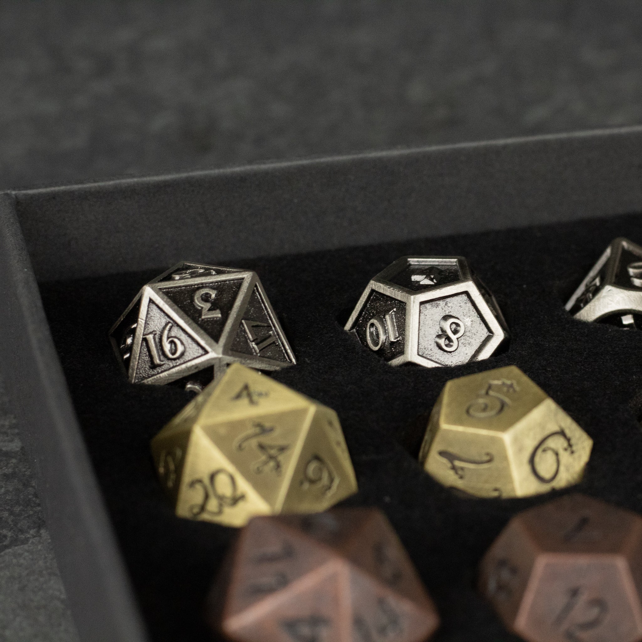 Metal Dice Set Gift Box - Set of metal polyhedral dice in silver, gold, and bronze, displayed in a black foam-lined gift box.