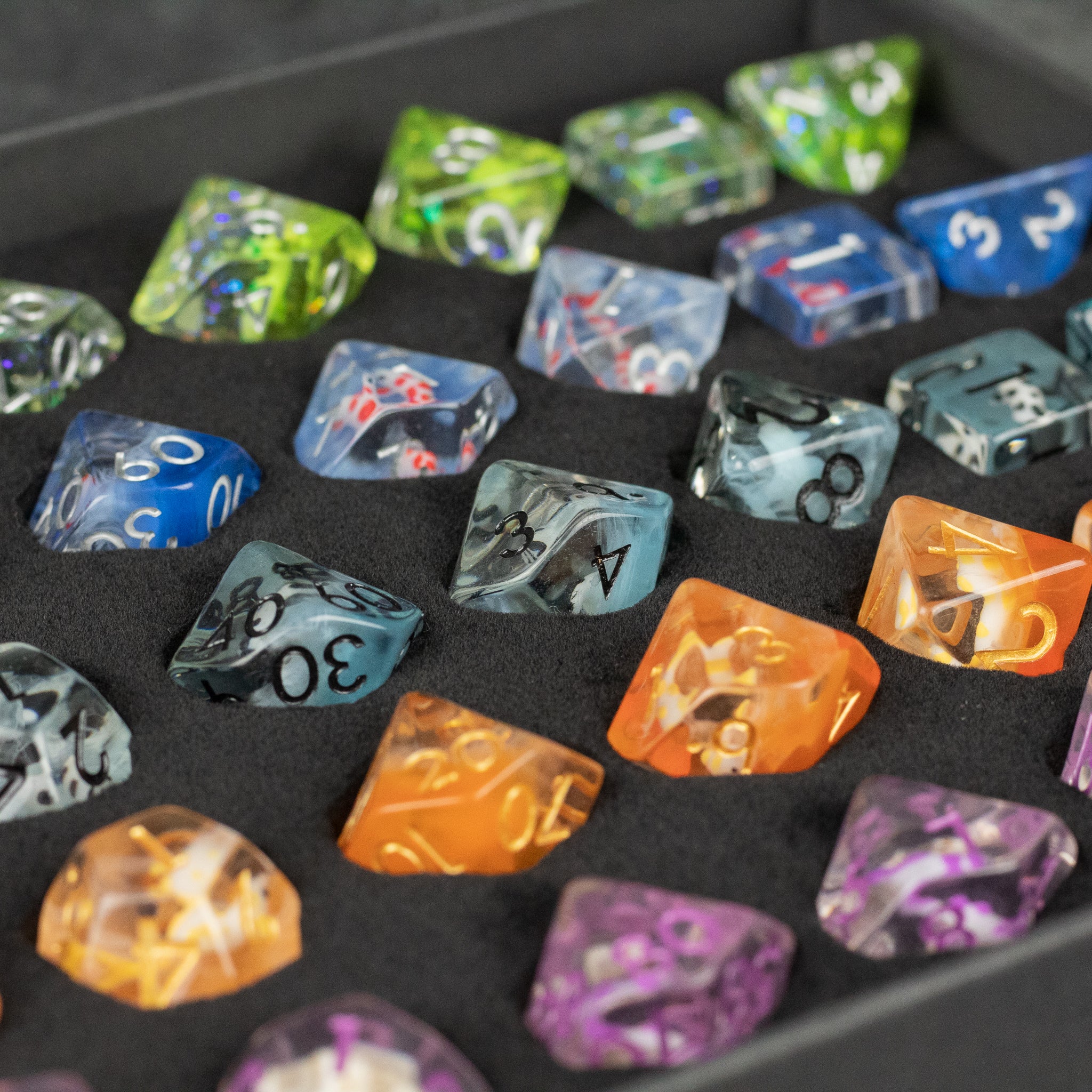 Koi Fish Dice Set Gift Box - Colorful translucent polyhedral dice set with intricate koi fish designs inside, arranged in a black foam tray.