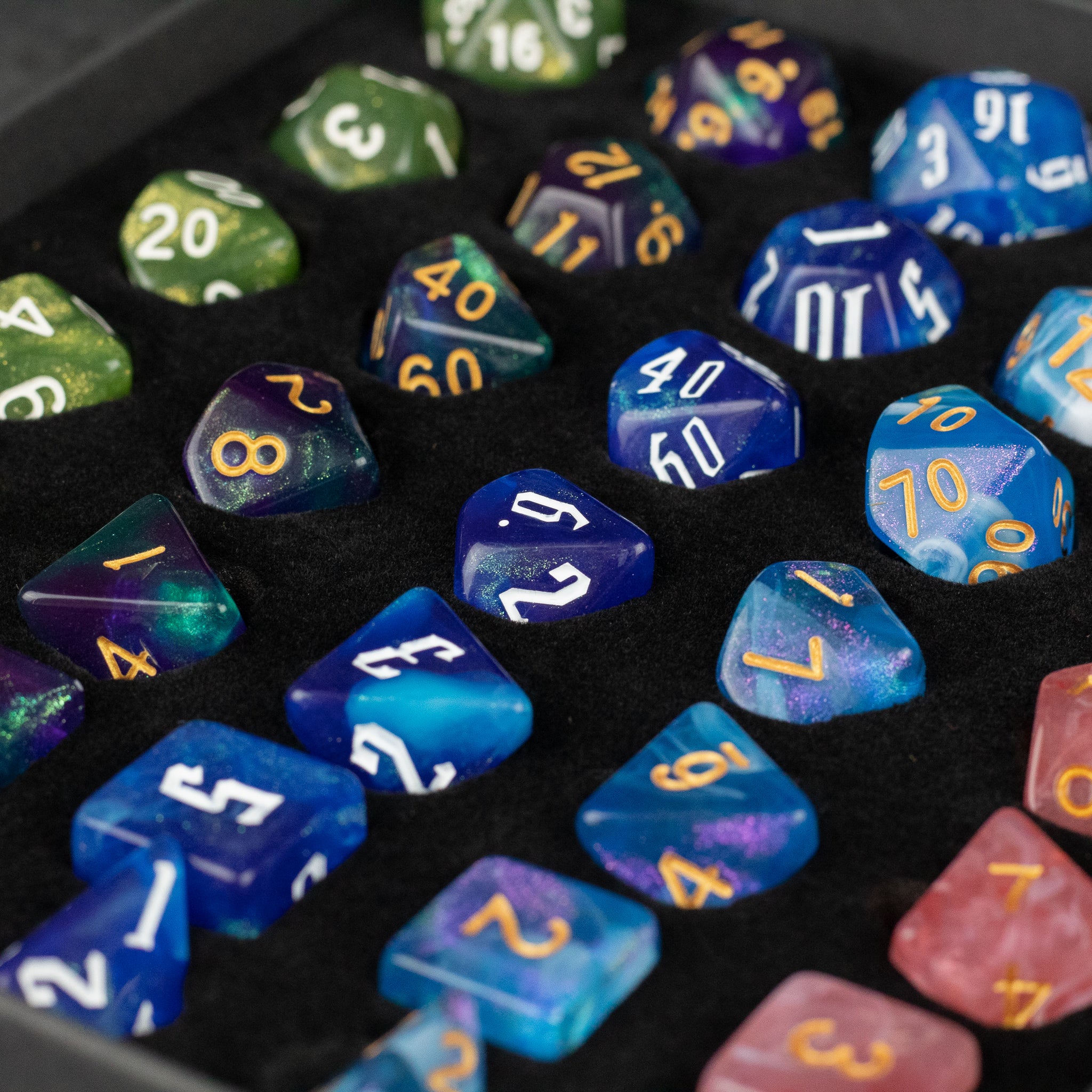 Acrylic Dice Set Gift Box - Multicolored acrylic polyhedral dice with gold and white numbering, displayed on black foam inside a gift box.