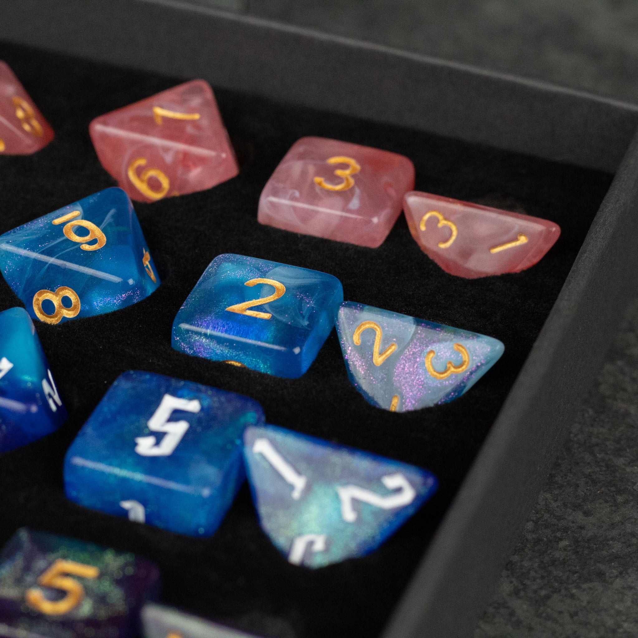 Acrylic Dice Set Gift Box - Colorful acrylic dice set with gold and white numbering in a black gift box tray.