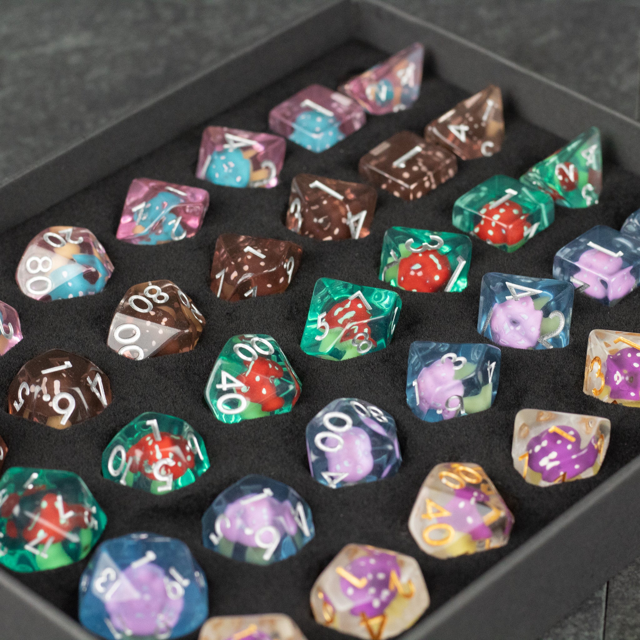Mushroom Dice Set Gift Box - Colorful polyhedral dice set with embedded miniature mushrooms, displayed in a black gift box.