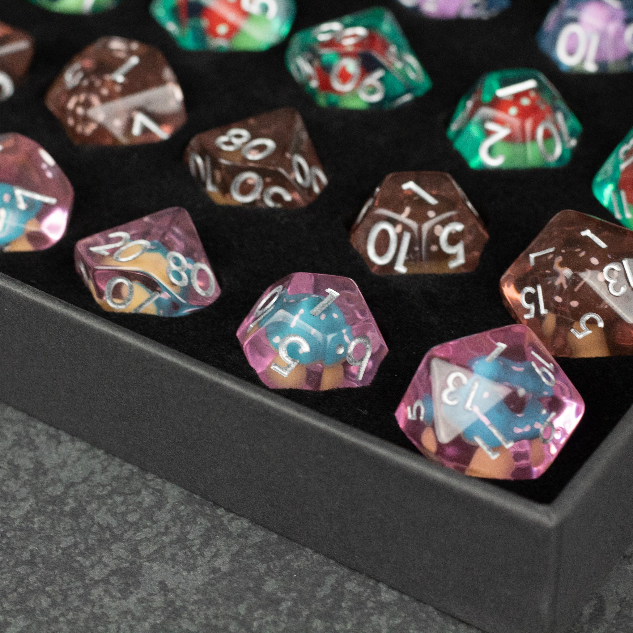 Mushroom Dice Set Gift Box - Multi-colored translucent mushroom-shaped polyhedral dice with white numbering in a black box.