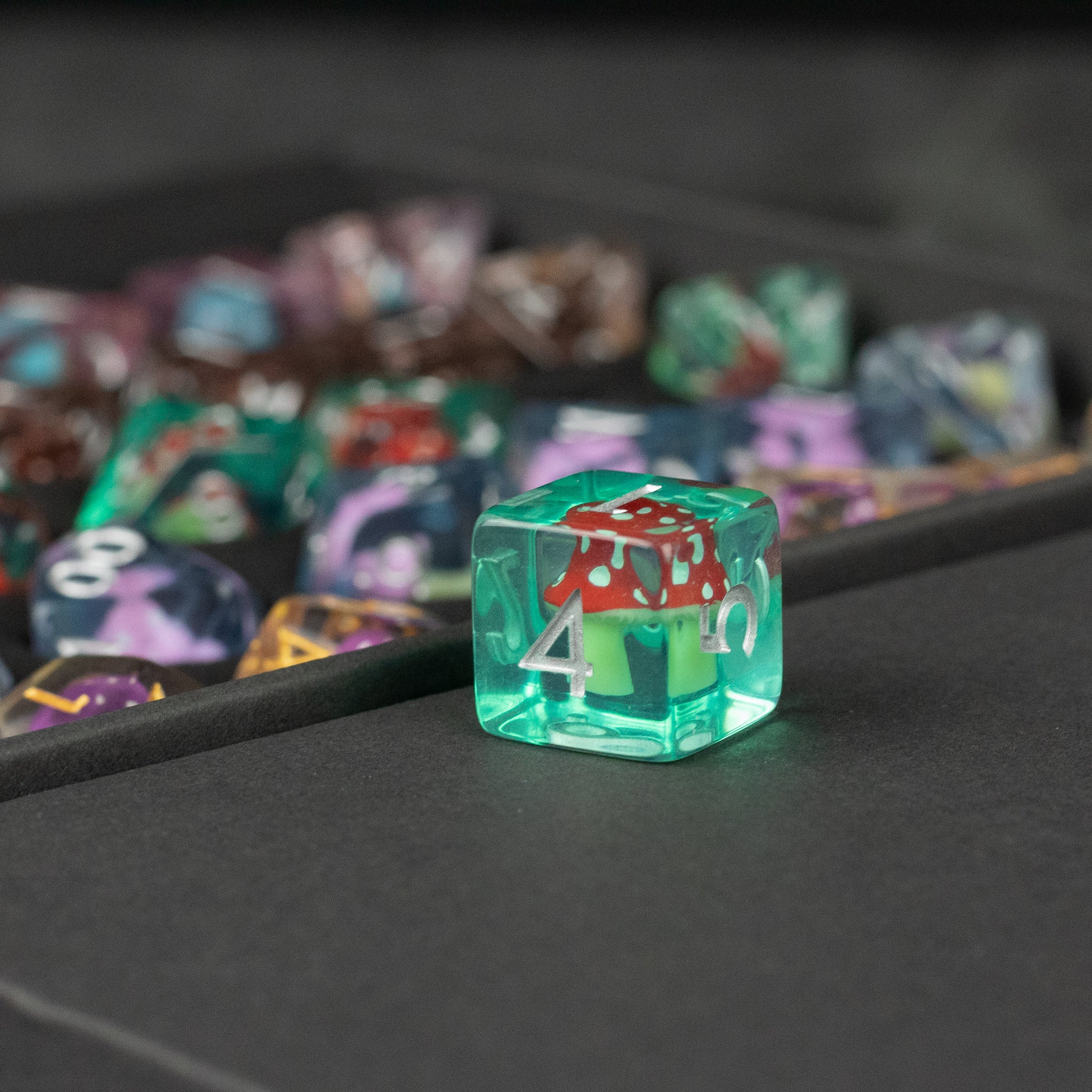Mushroom Dice Set Gift Box - Translucent green six-sided die with a red and white mushroom inside and white numbers on each face.