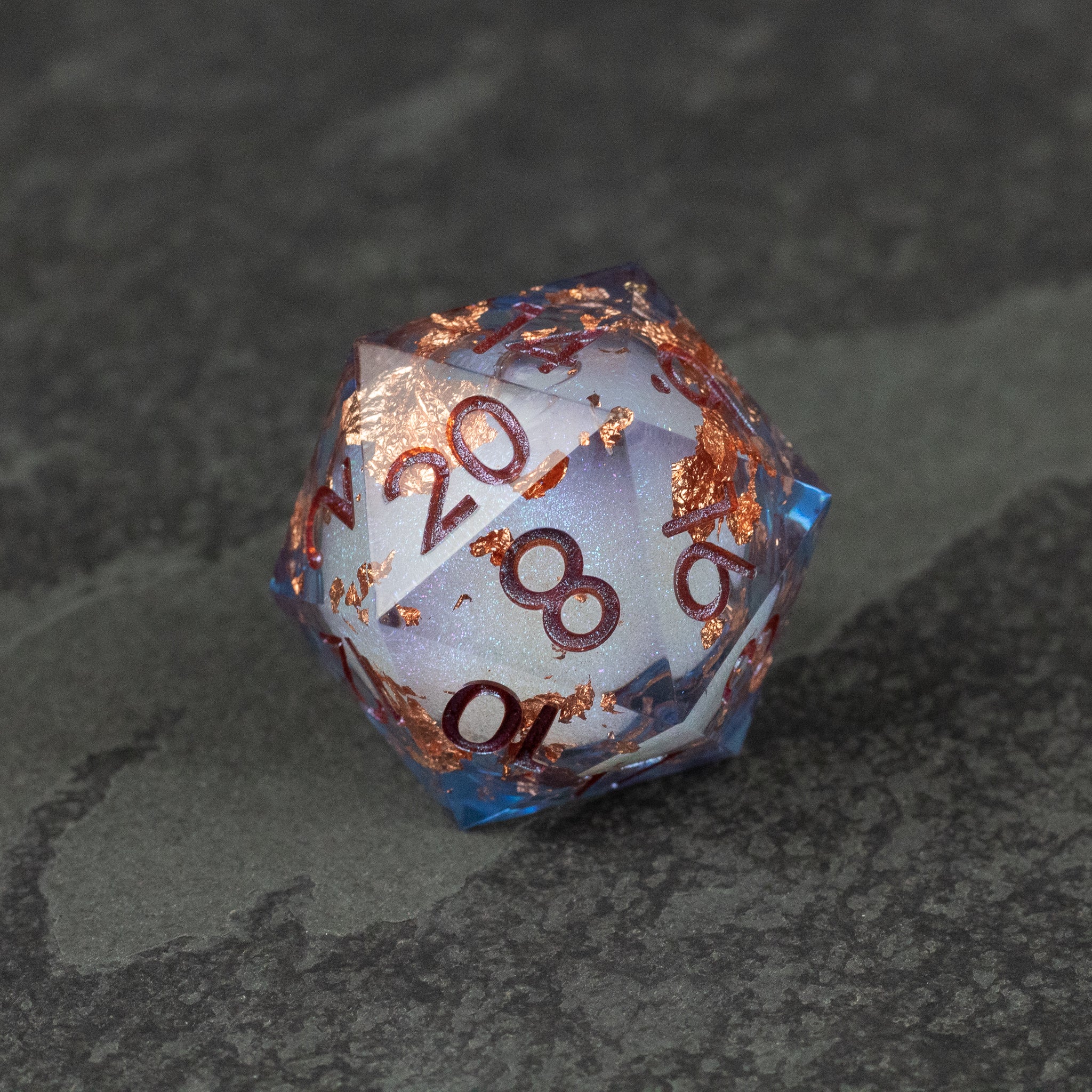 33mm Liquid Core D20 Chonk - Blue + Foil - 33mm blue d20 giant dice with liquid core and copper foil accents on dark background.