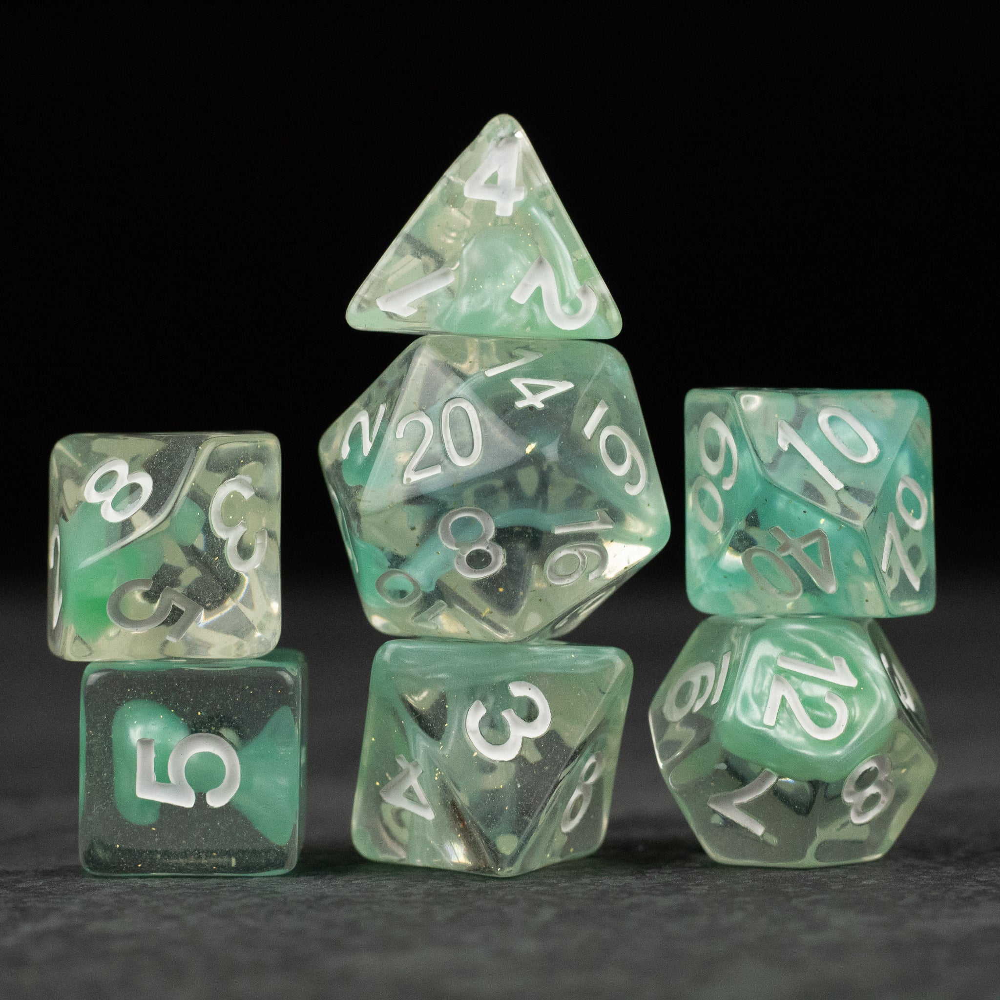 Cyan Lava Lamp Dice Set - Set of seven translucent cyan polyhedral dice with white numbers, including d4, d6, d8, d10, d12, d20, and percentile dice.