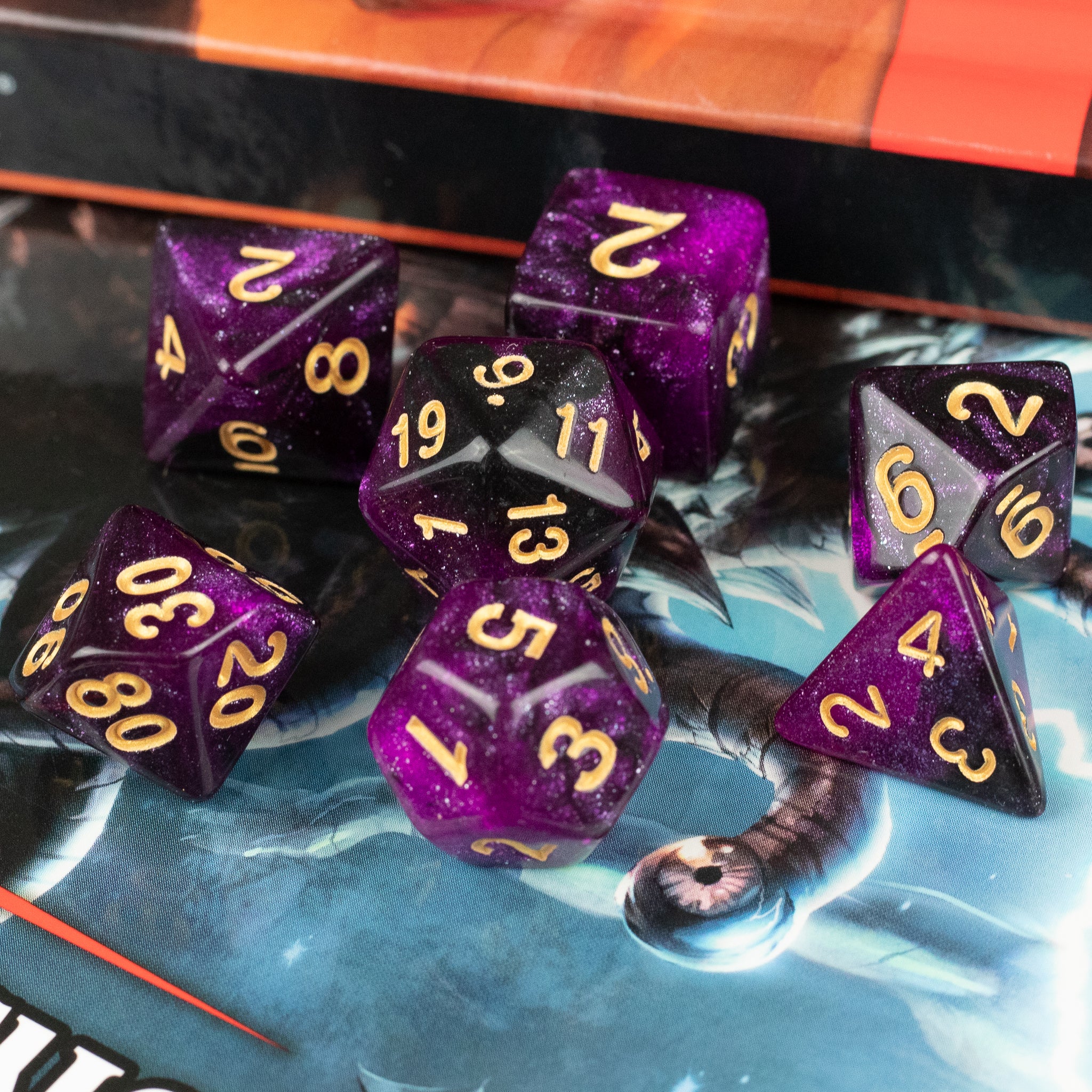 Purple and Black Glitter Dice Set - Seven purple and black glitter polyhedral dice with gold numbers for tabletop gaming.