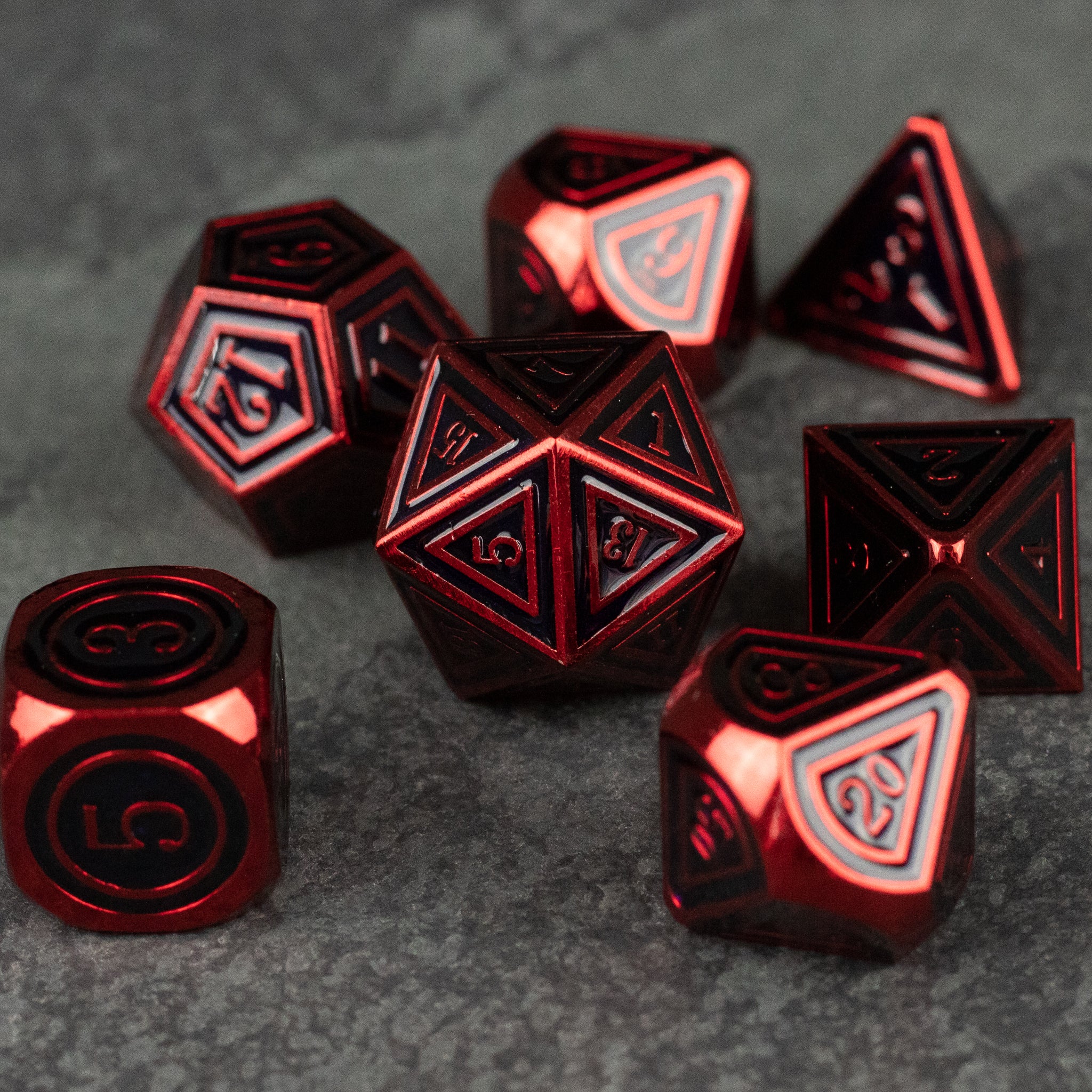 Crimson Ritual Dice Set - Metallic red polyhedral dice set with intricate black and silver detailing on each face.