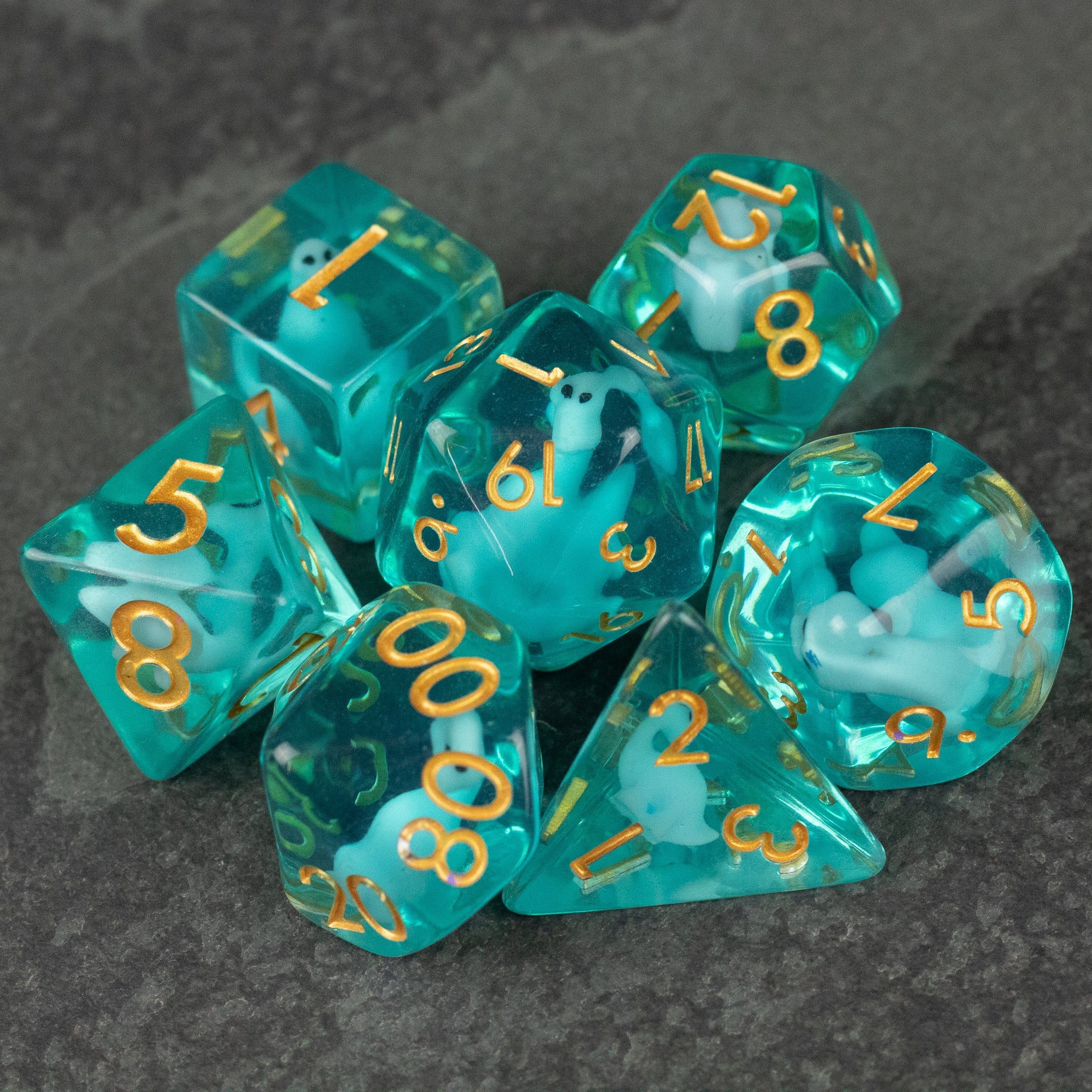 Blue Brontosaurus Dice Set - Translucent blue polyhedral dice set with gold numbers, including d4, d6, d8, d10, d12, and d20 shapes.