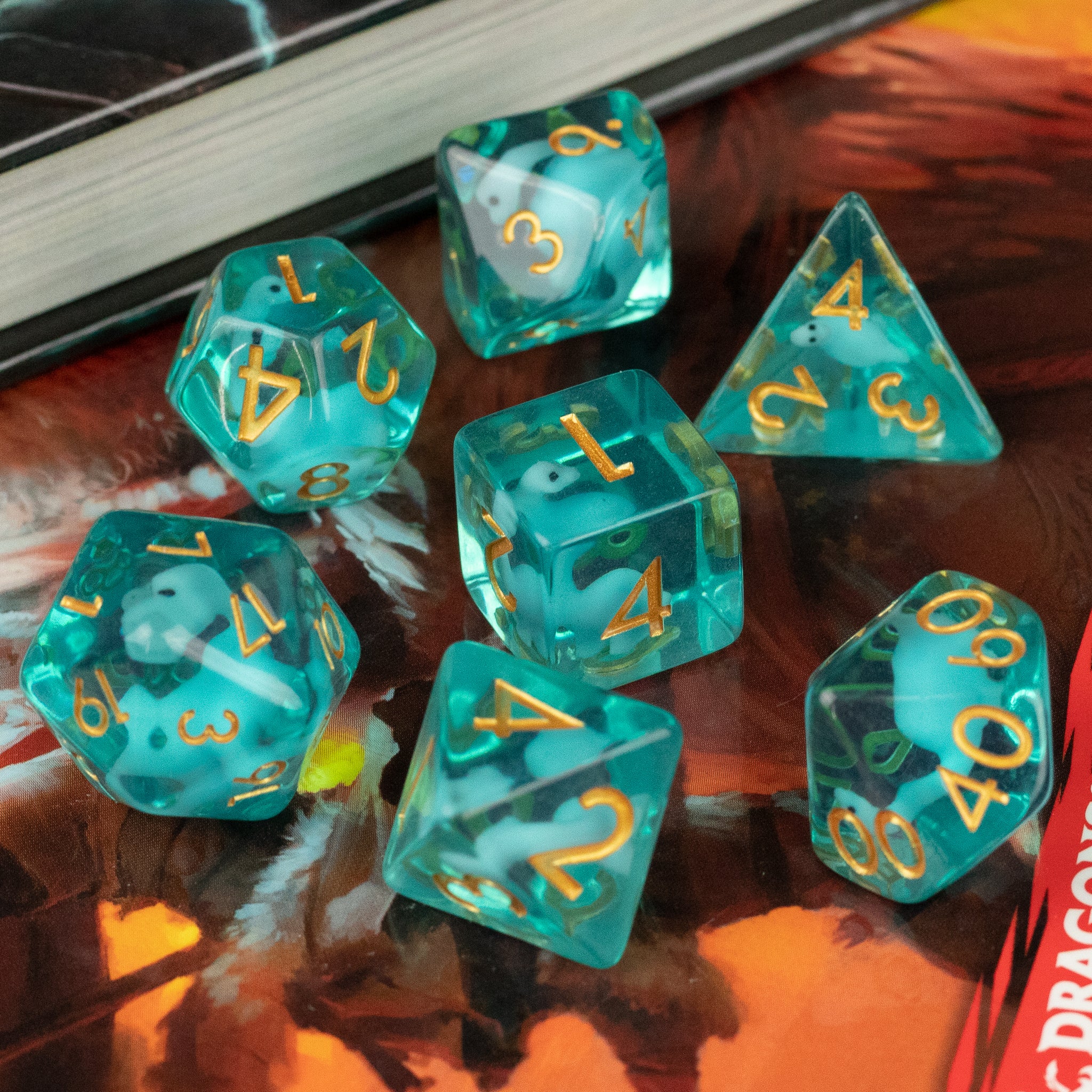 Blue Brontosaurus Dice Set - Blue translucent Brontosaurus-themed polyhedral dice set with gold numbers on reflective surface.