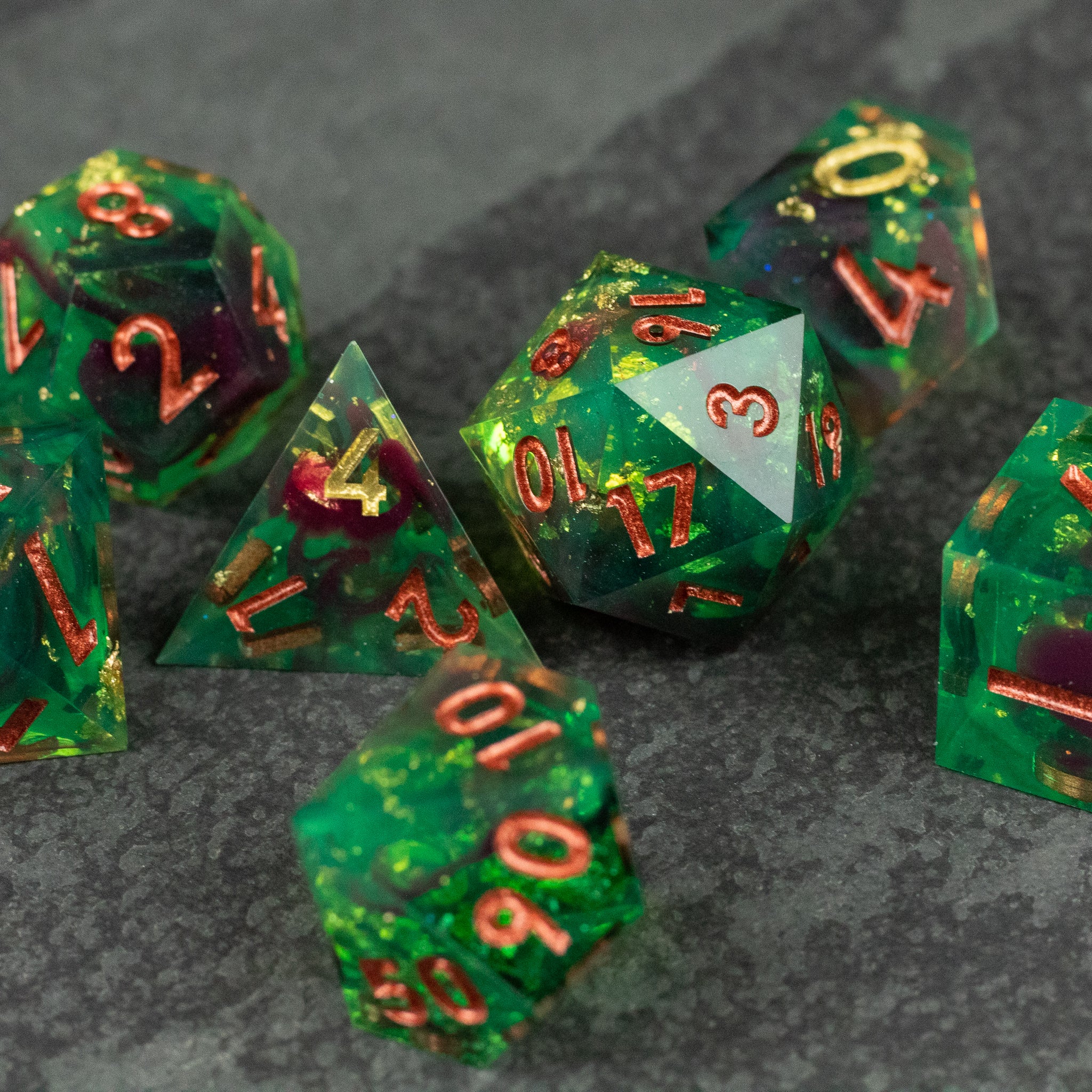 Primal Blood Dice Set - Green translucent sharp-edged polyhedral dice set with red numbering and gold glitter accents.