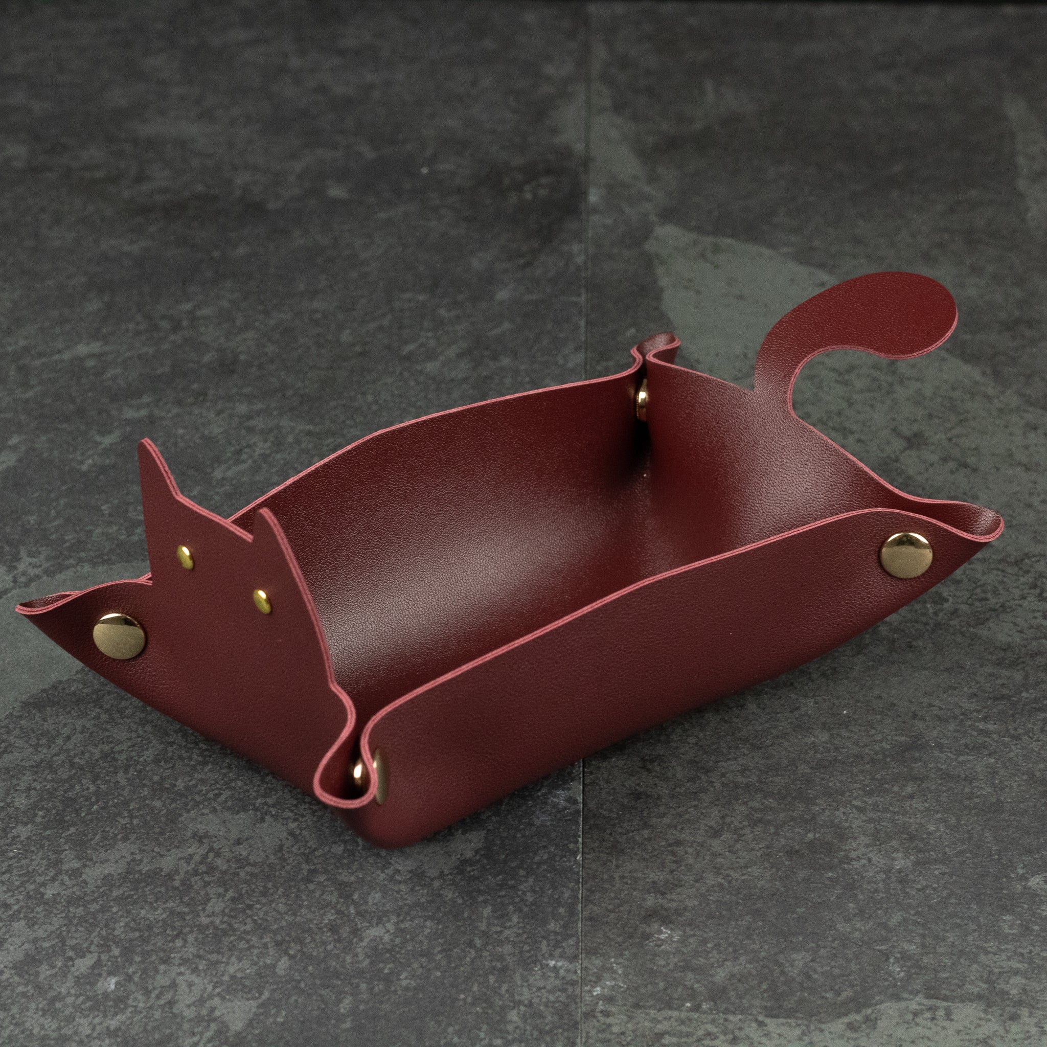 Cat Shaped Dice Tray - Red leather dice tray shaped like a cat with folded corners forming ears and a curled tail detail.