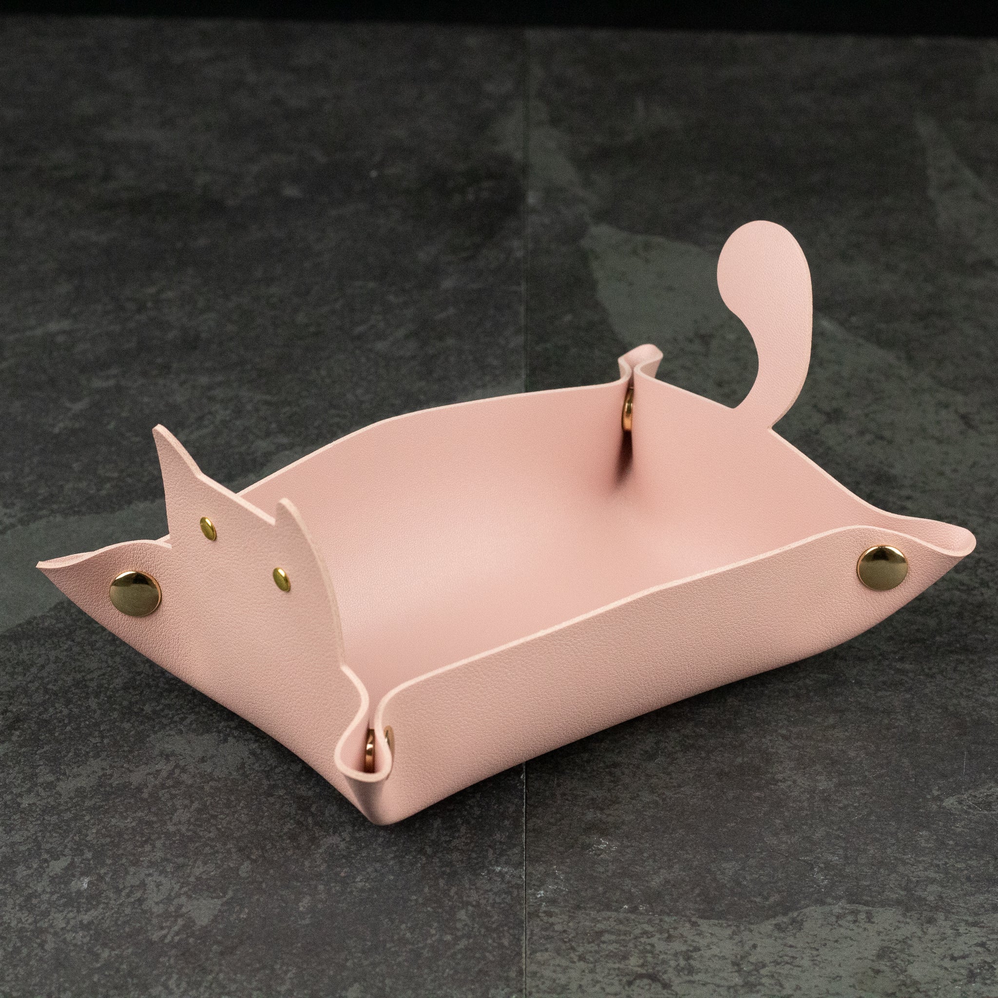 Cat Shaped Dice Tray - Light pink leather dice tray shaped like a cat with brass snap buttons and raised tail sides.