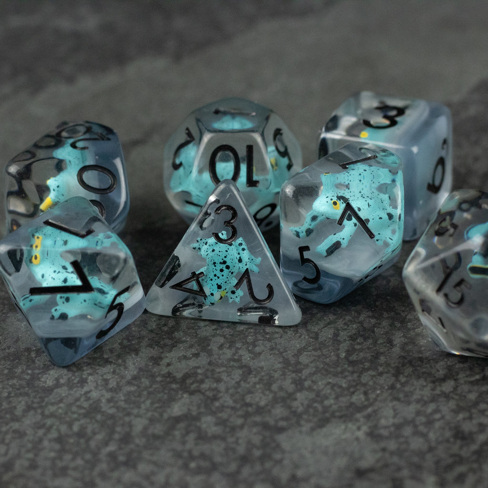 Blue Frog Dice Set - Set of translucent blue polyhedral dice with black numbers and speckles, including d4, d6, d8, d10, d12, and d20 shapes.