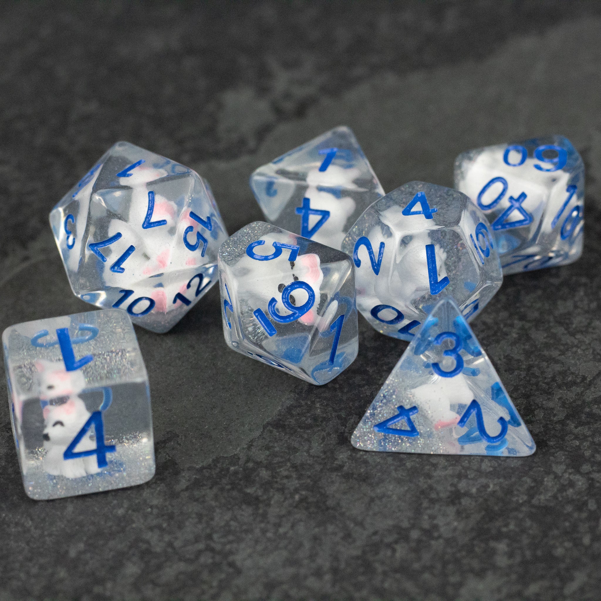 Artic Fox Dice Set - Translucent dice set with blue and pink numbers, featuring various polyhedral shapes.