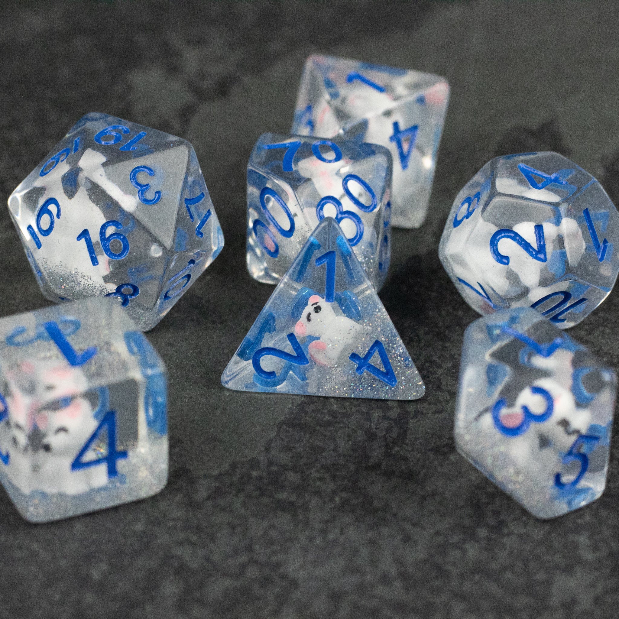 Artic Fox Dice Set - Clear polyhedral dice set with blue numbers featuring inclusions resembling icy white fox fur patterns.