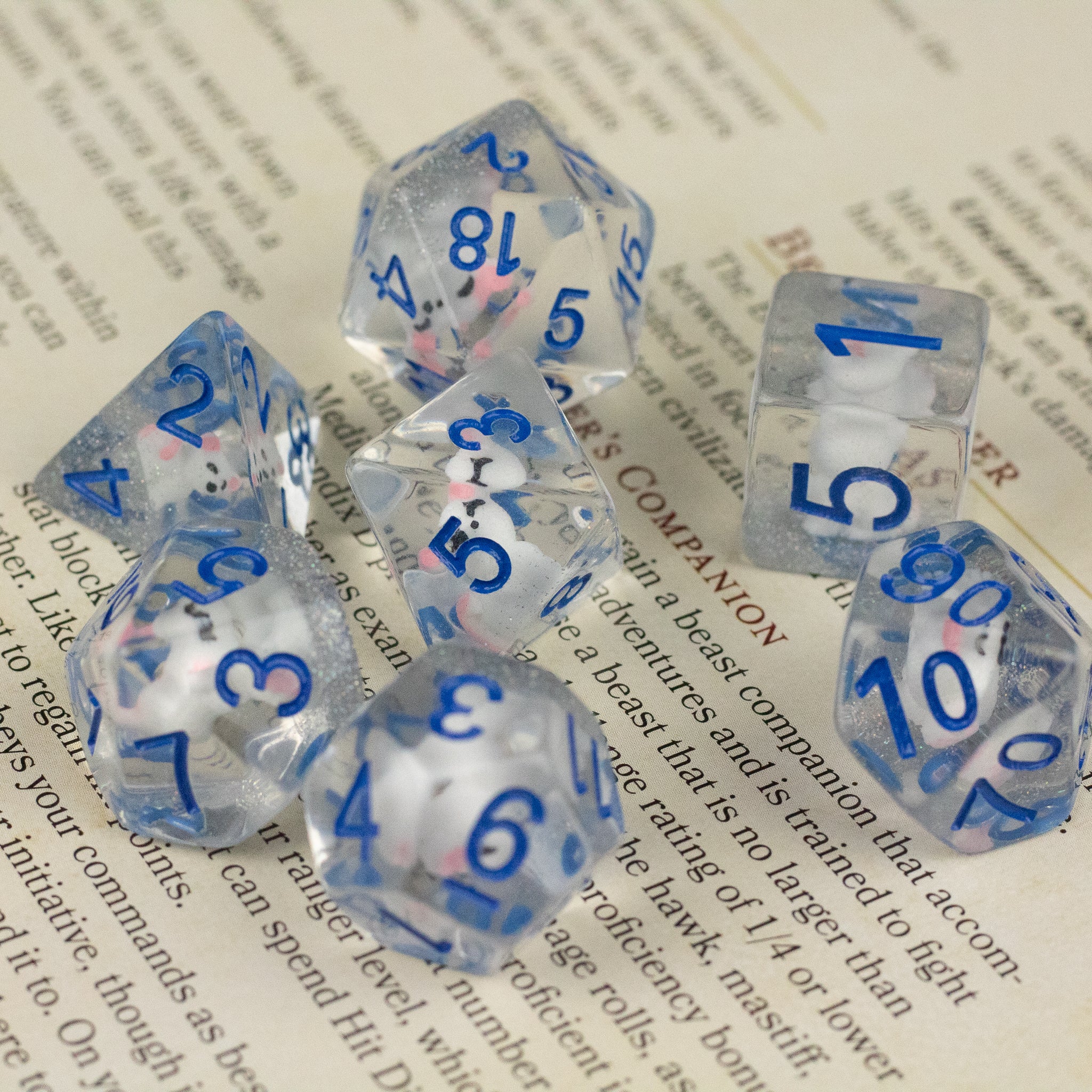 Artic Fox Dice Set - Clear translucent polyhedral dice set with blue numbers, including d20, d12, d10, d8, d6, and d4 shapes.