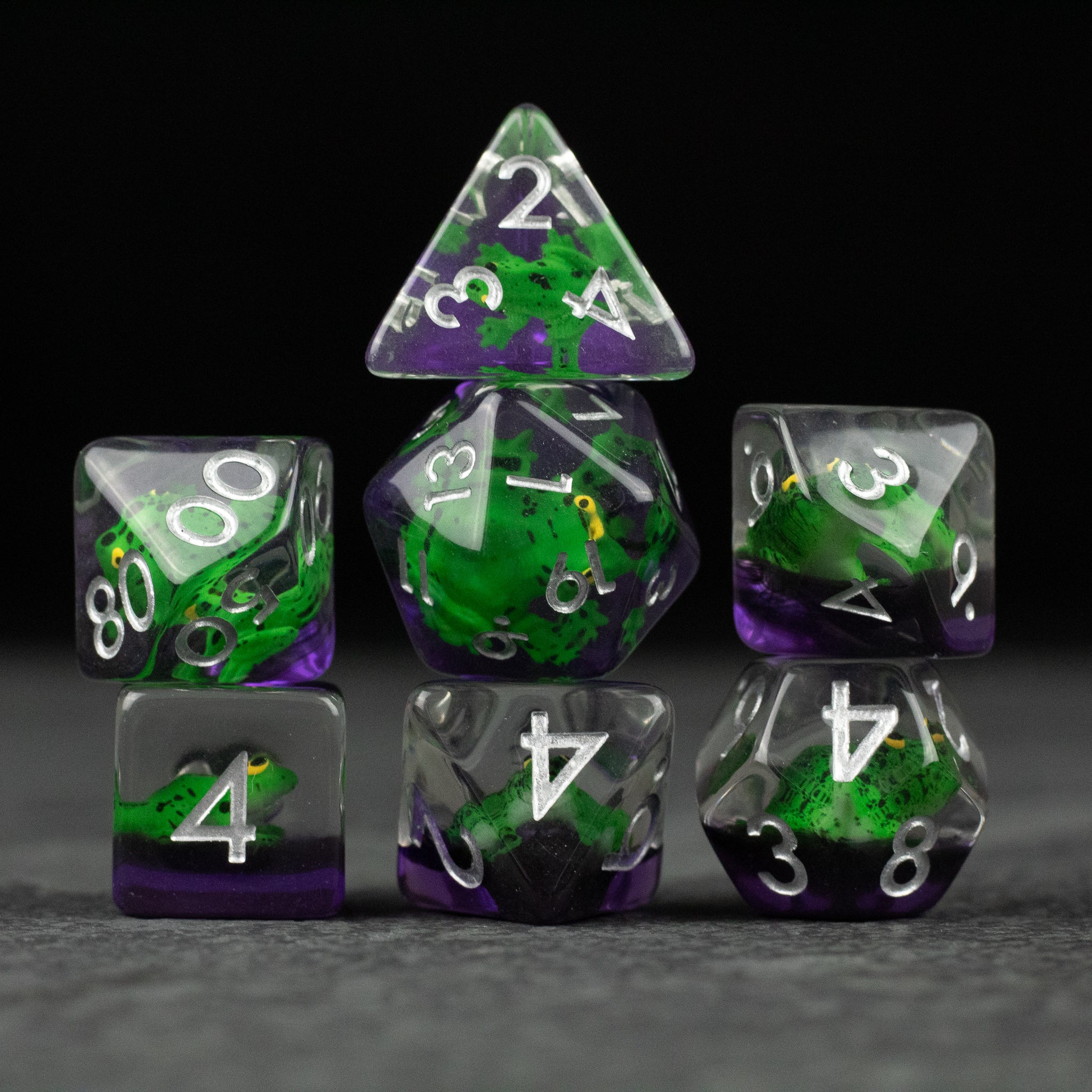 Green Frog Dice Set - Green and purple translucent polyhedral dice set with white numbers and frog design inside.