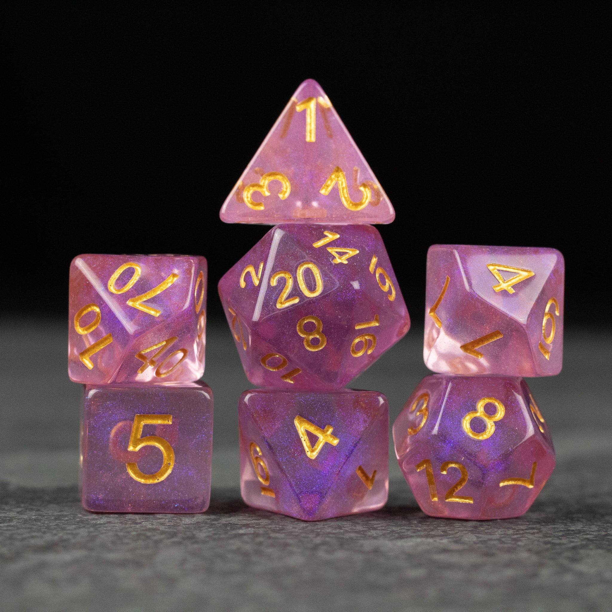 Purple Aura Glitter Dice Set - Purple semi-translucent glitter dice set with gold numbering, including d4, d6, d8, d10, d12, d20, and percentile dice.