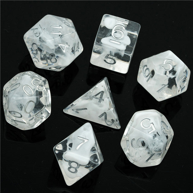 White Swirl Dice Set - Seven transparent dice with white swirling patterns and silver numbers on a black background.